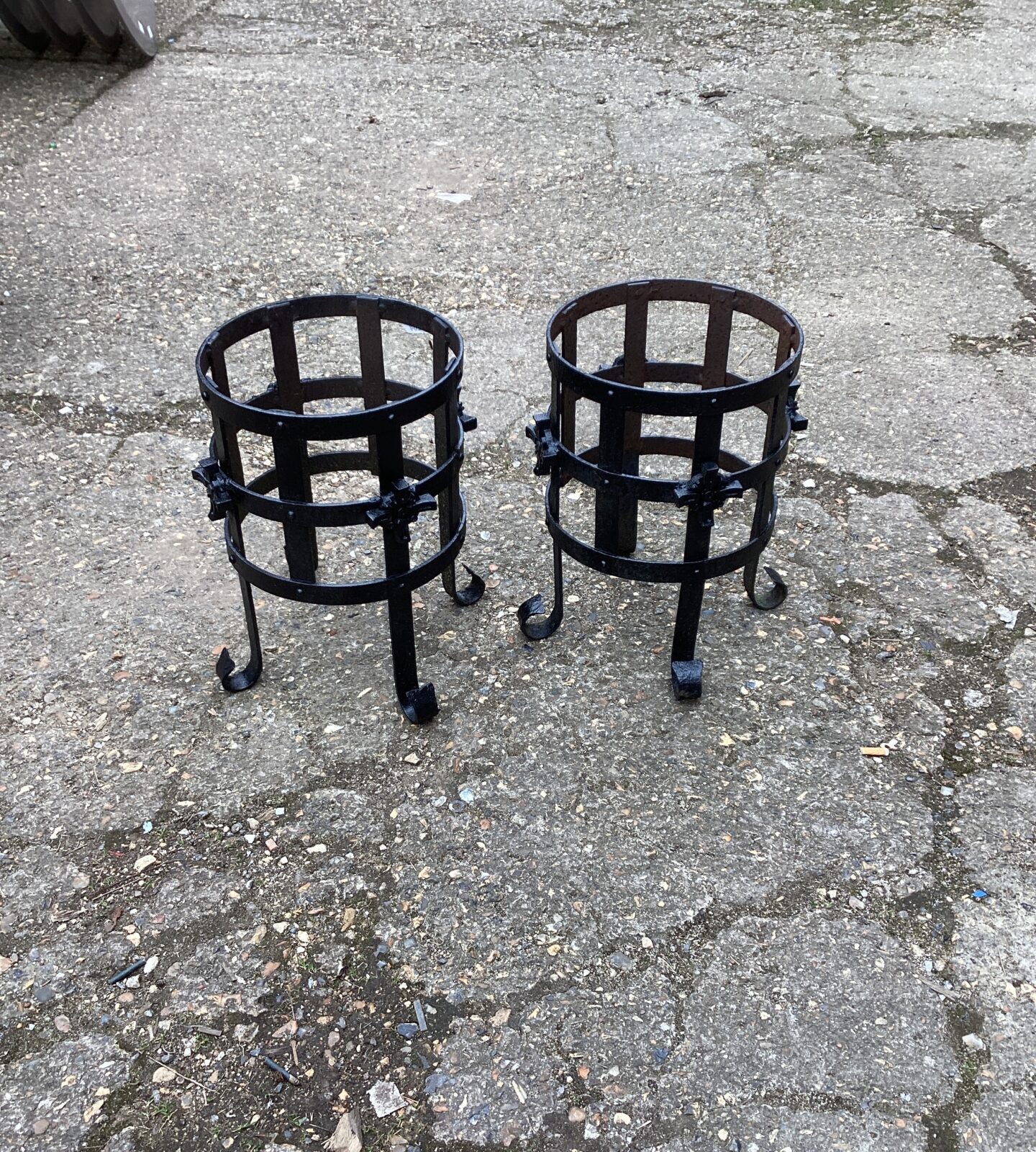 Two metal garden plant pot stands