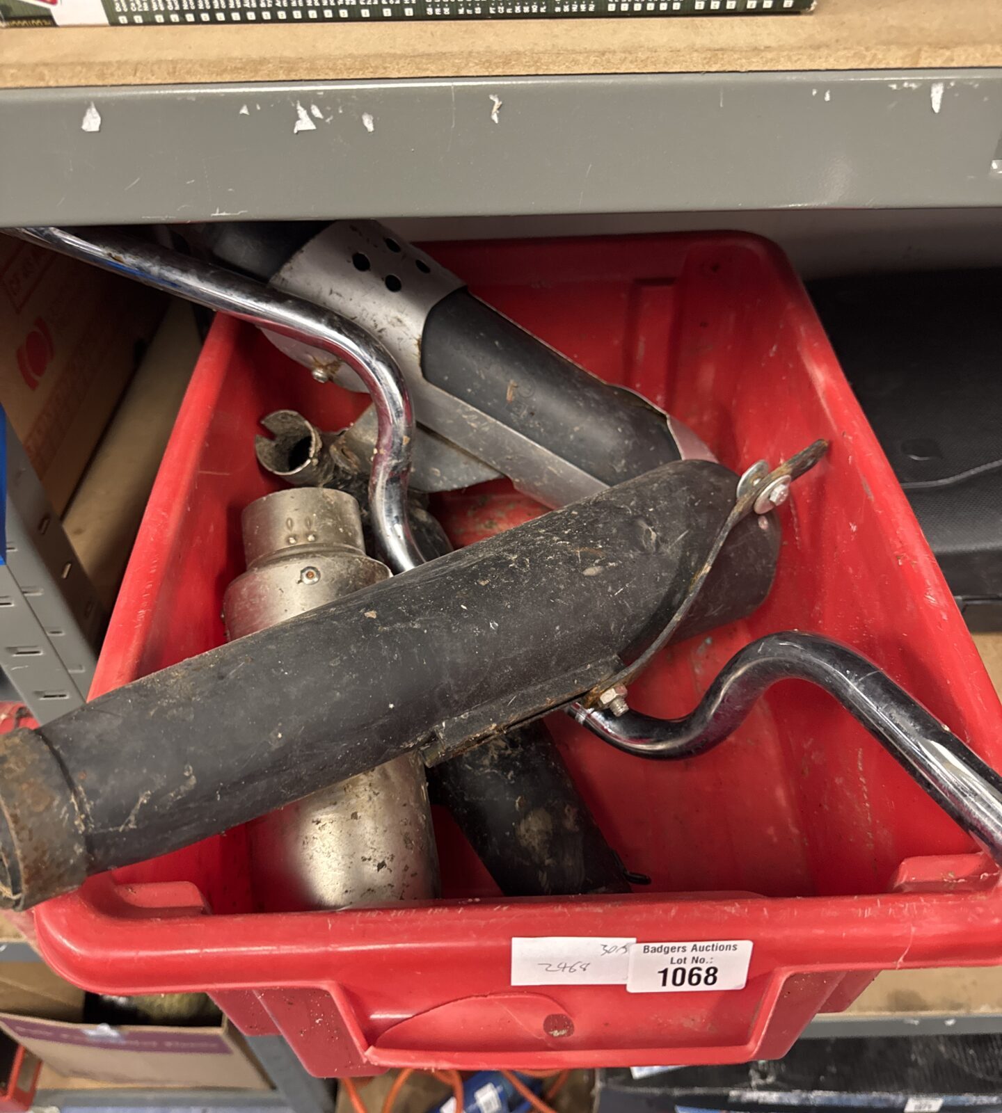 Box of motorcycle parts inc silencers & handlebars