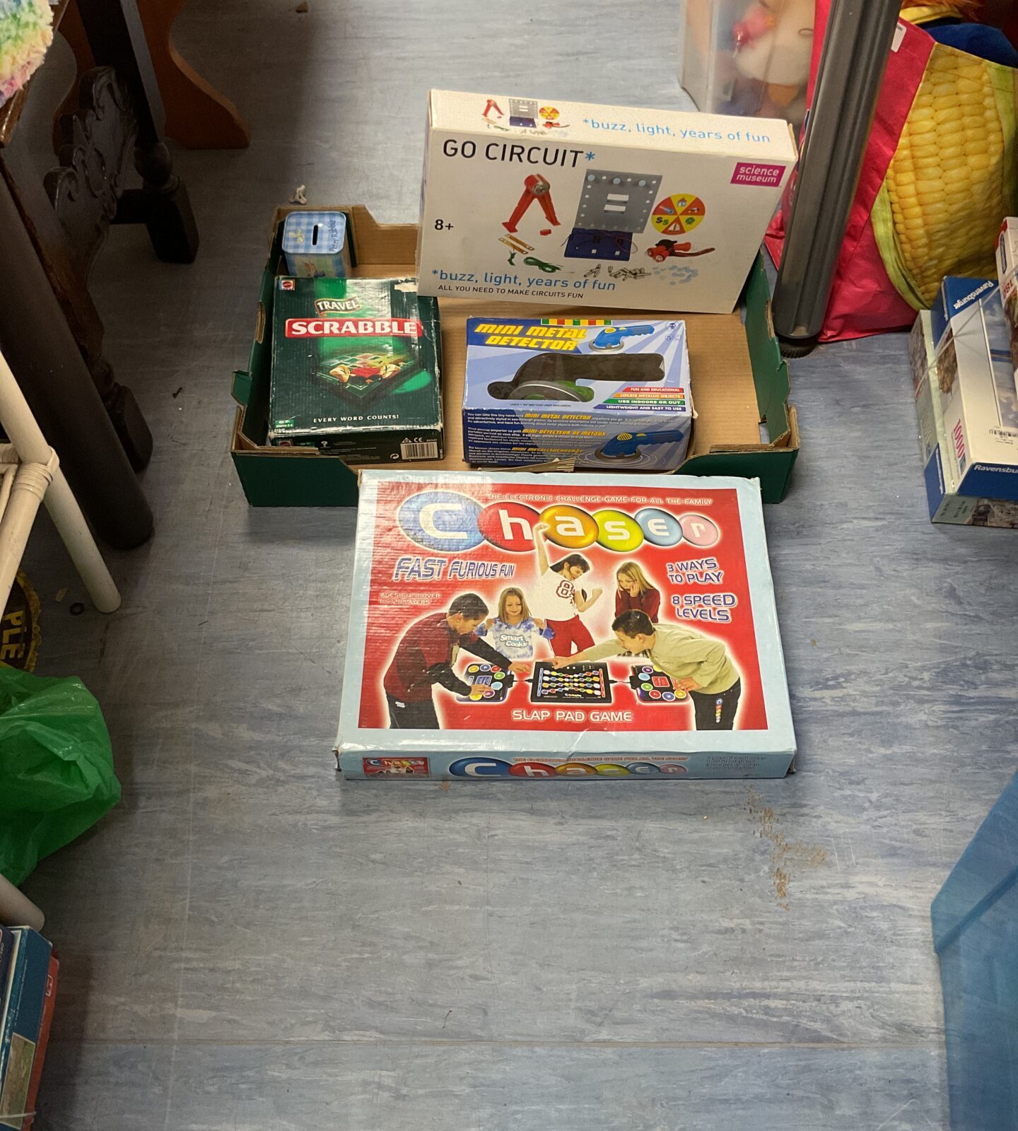 Box of mixed toys and games inc chaser, scrabble and go circuit set