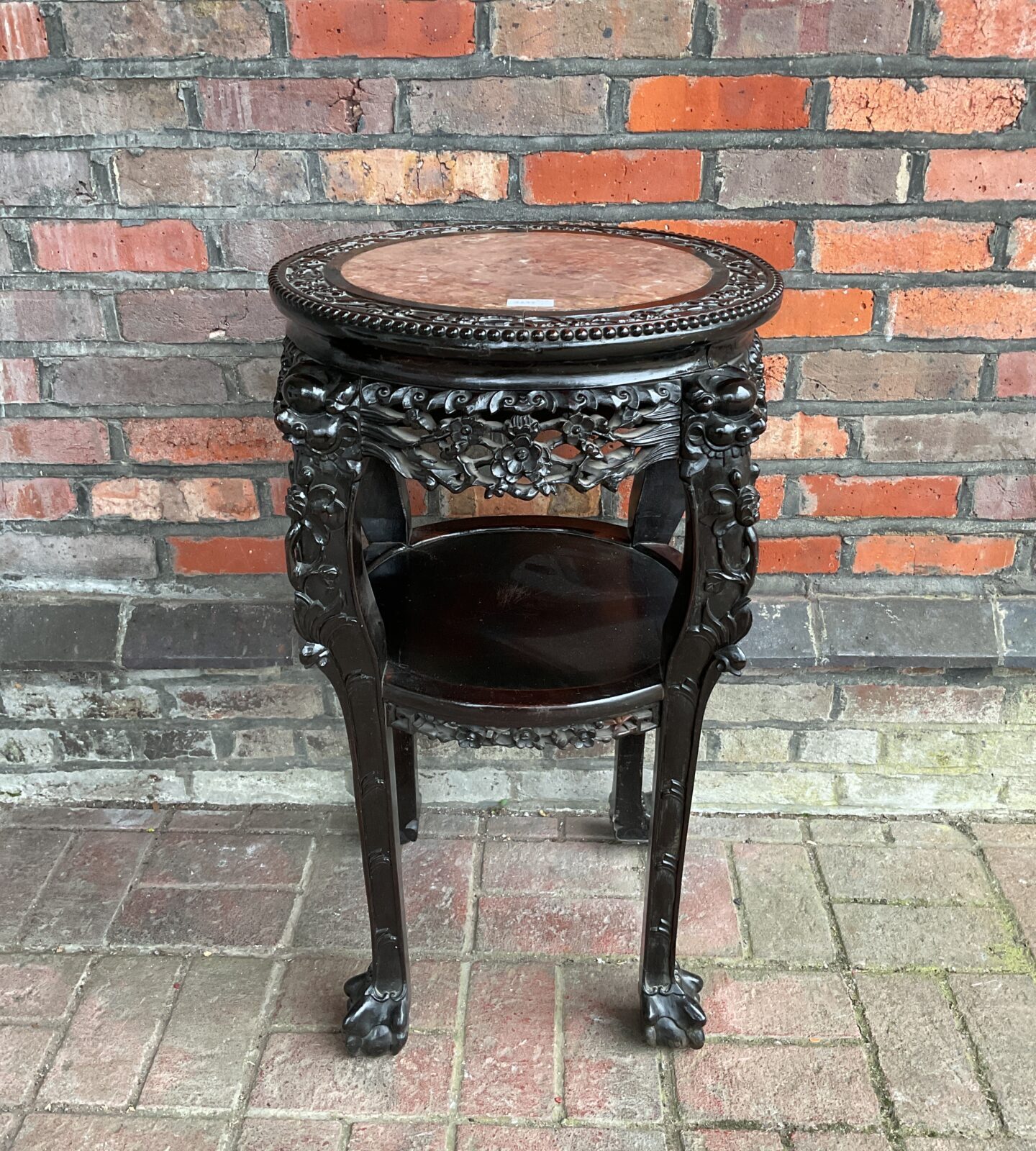 Chinese hardwood two tier circular occasional table with inset marble top with heavily carved frame