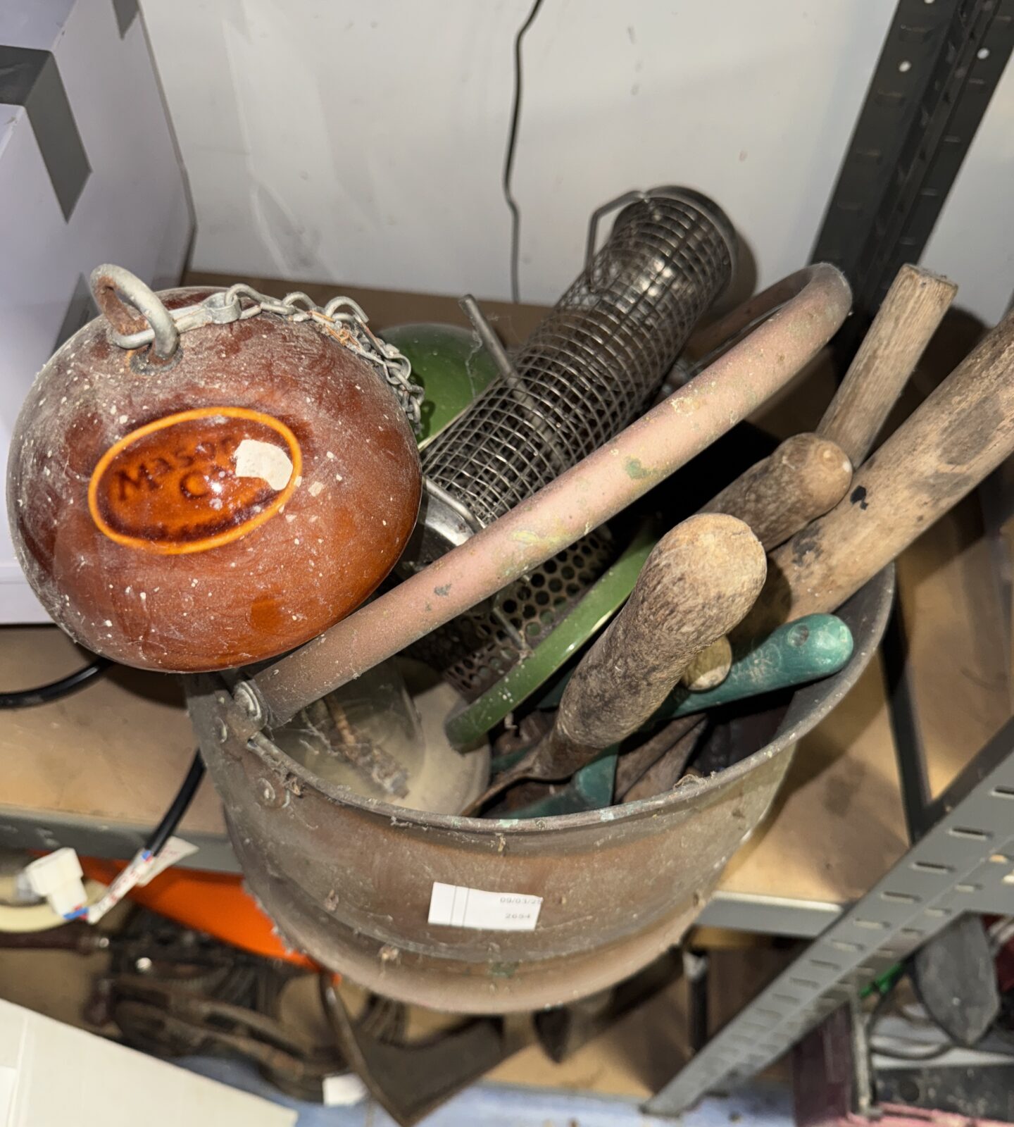 Copper coal bucket with mixed garden items contents