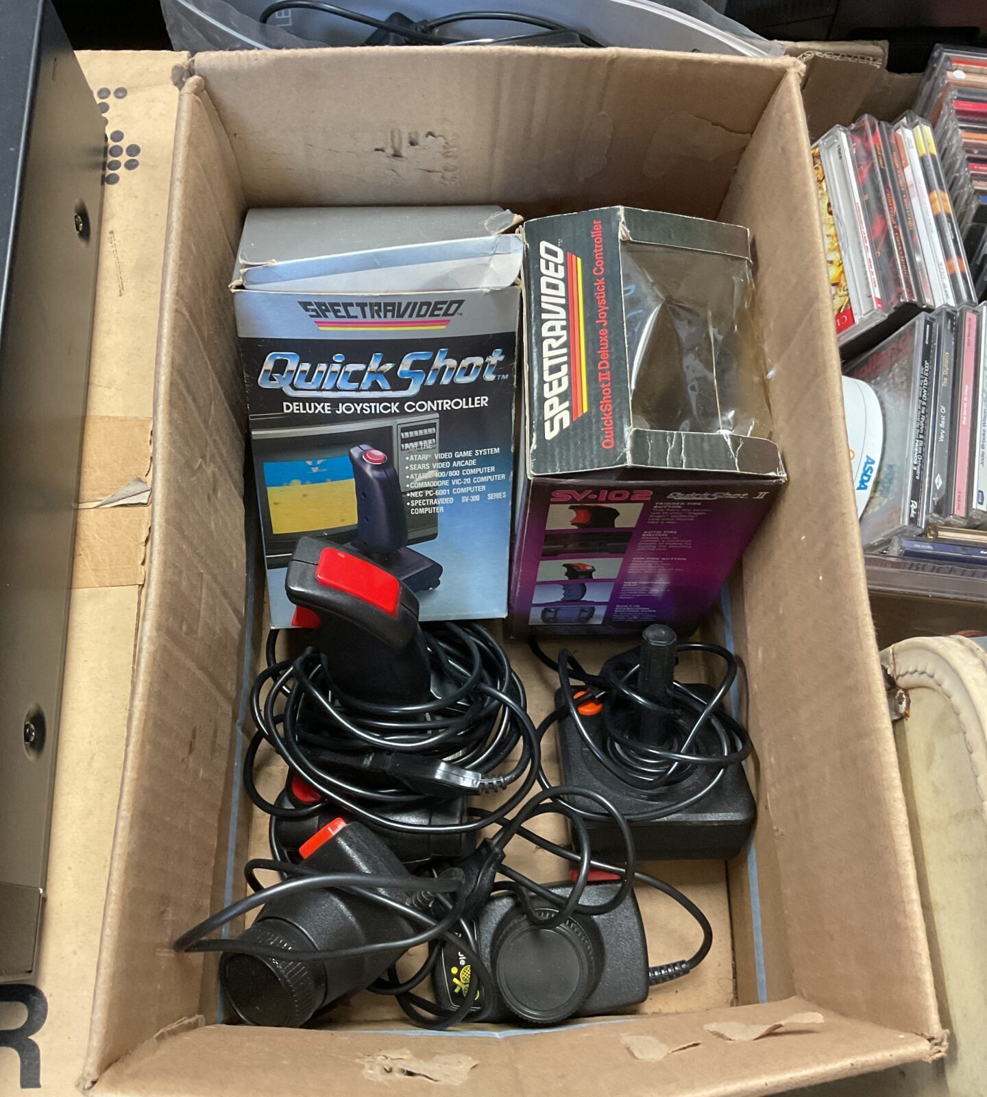 Box of atari joysticks & paddles