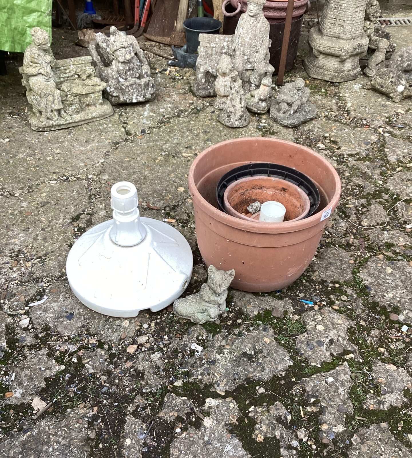 Patio parasol base with garden pots etc