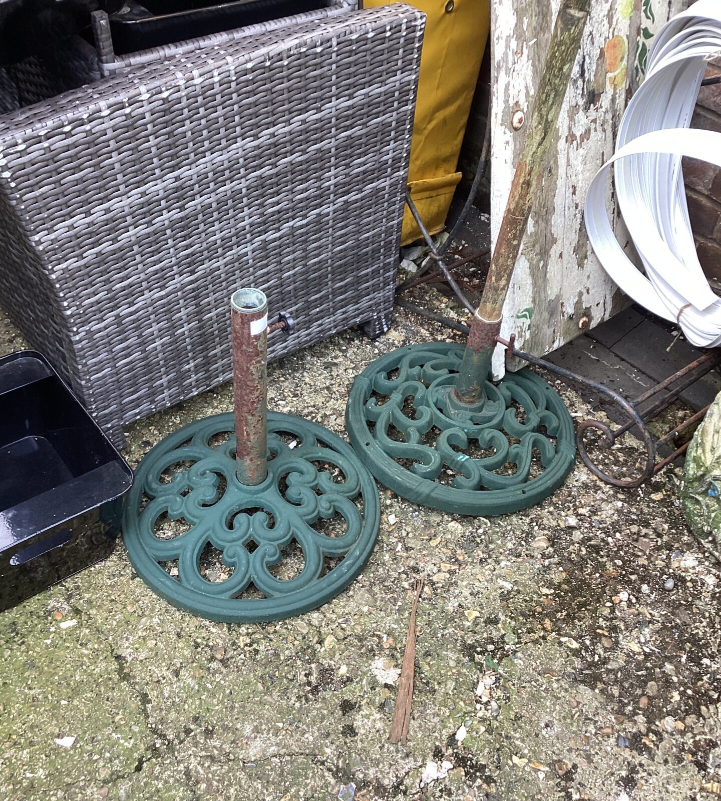 Two metal patio parasol bases