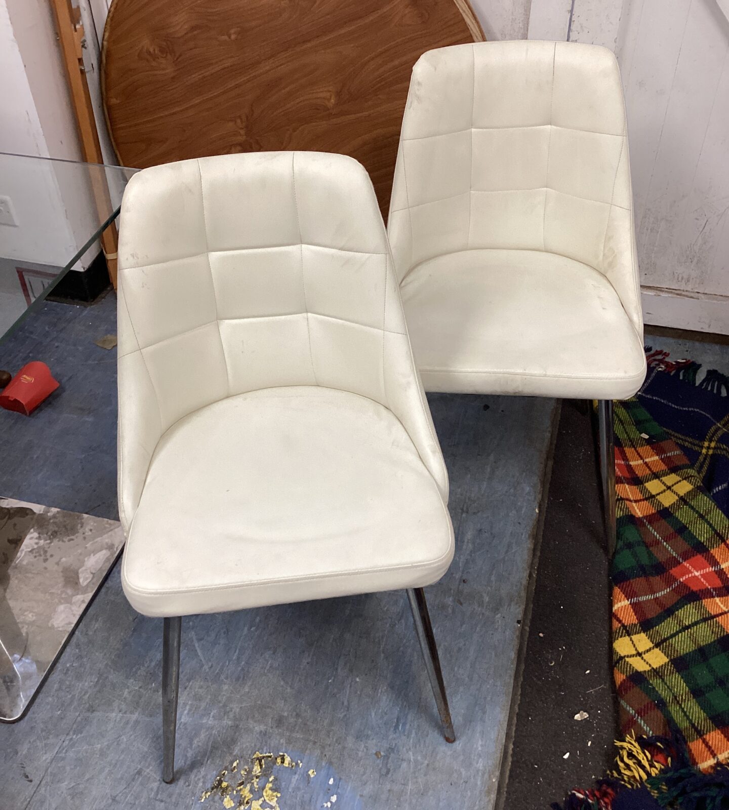 Two white leather reception chairs