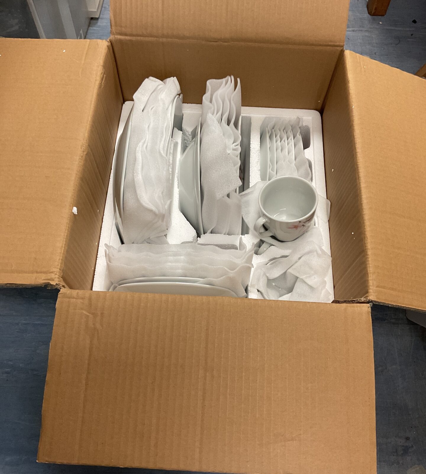 Box containing dinner service