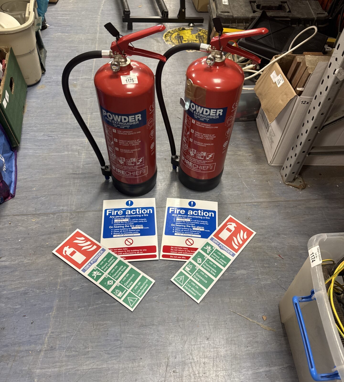 Two full powder fire extinguishers with warning signs