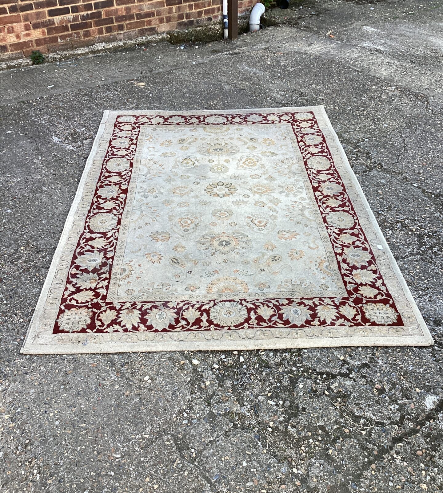 red floral patten rug approximately 7ft x 5ft
