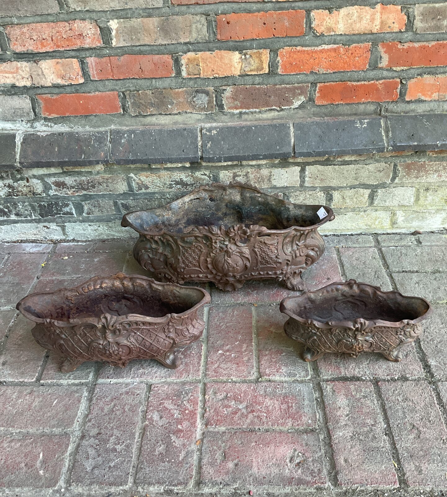 Set of three antique french graduated cast iron planters