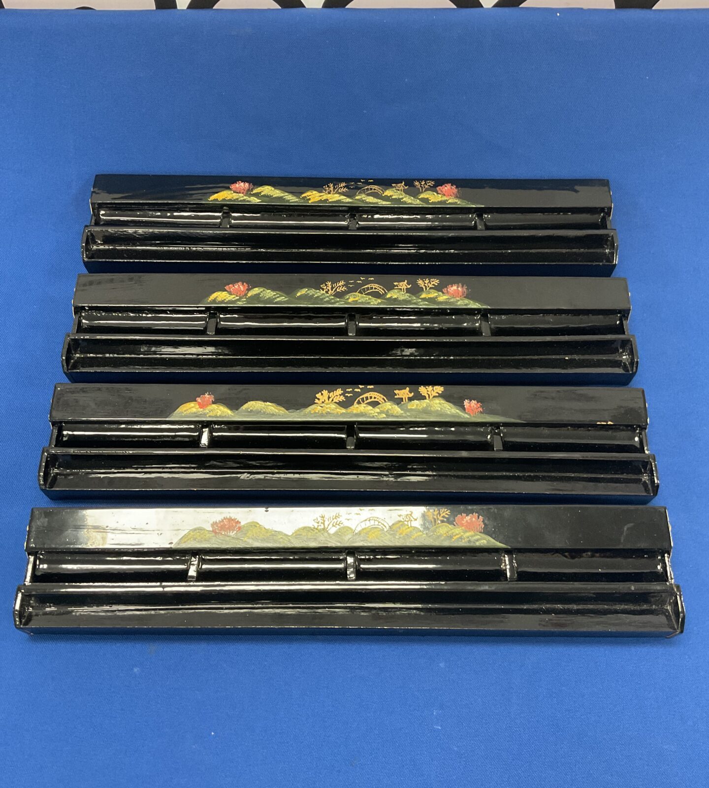 Four black lacquered mahjong tile walls