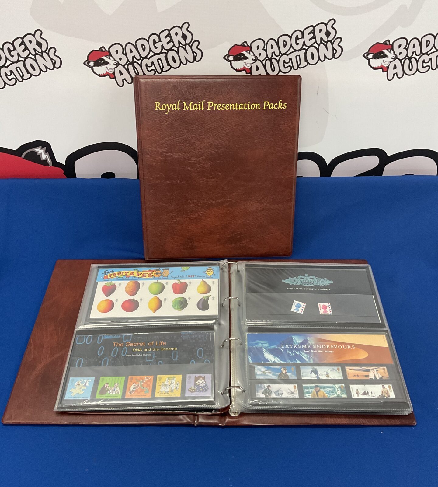 Two folders full of royal mail stamp presentation sets