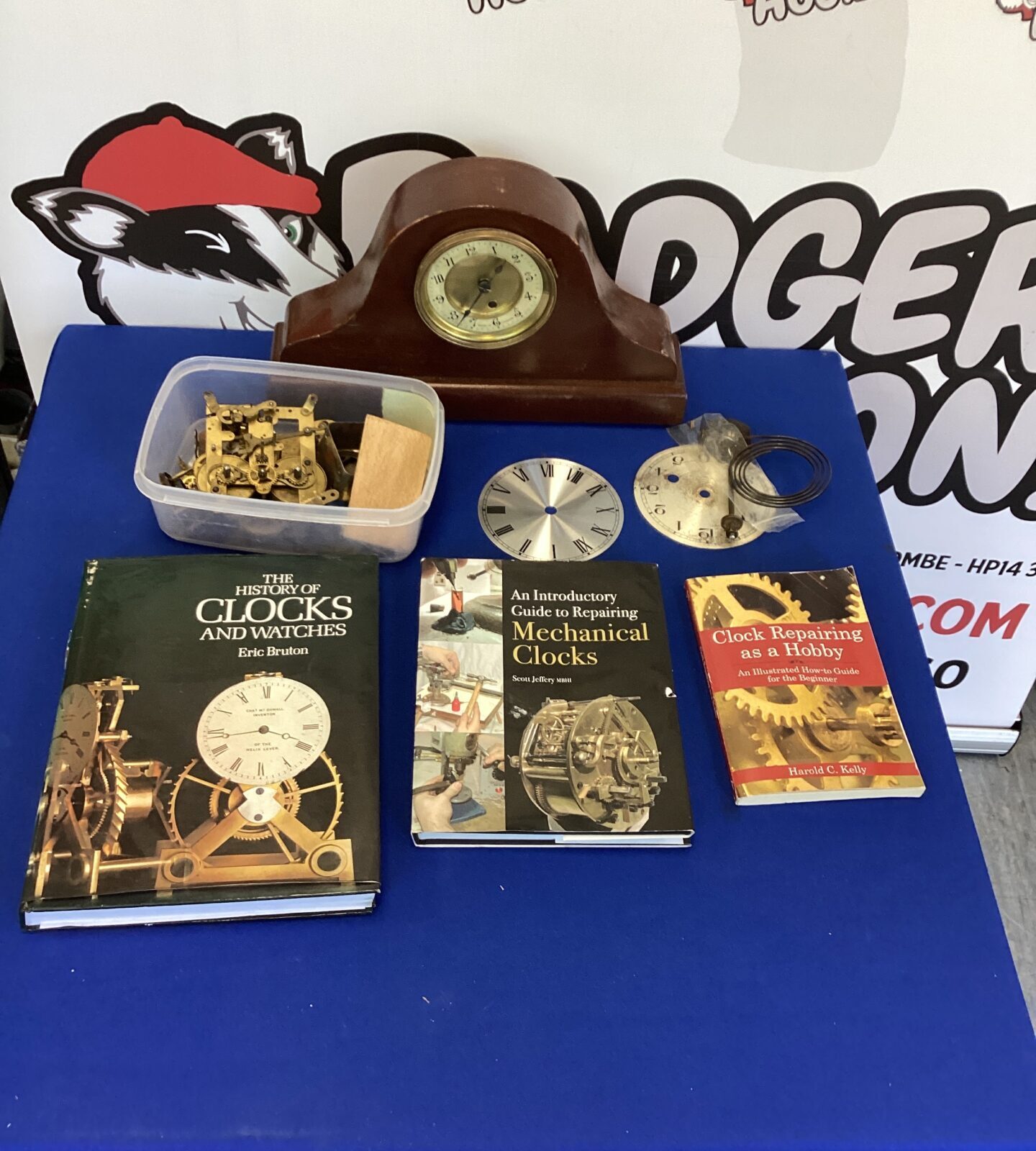 Vintage clock for repair with clock maintenance reference books