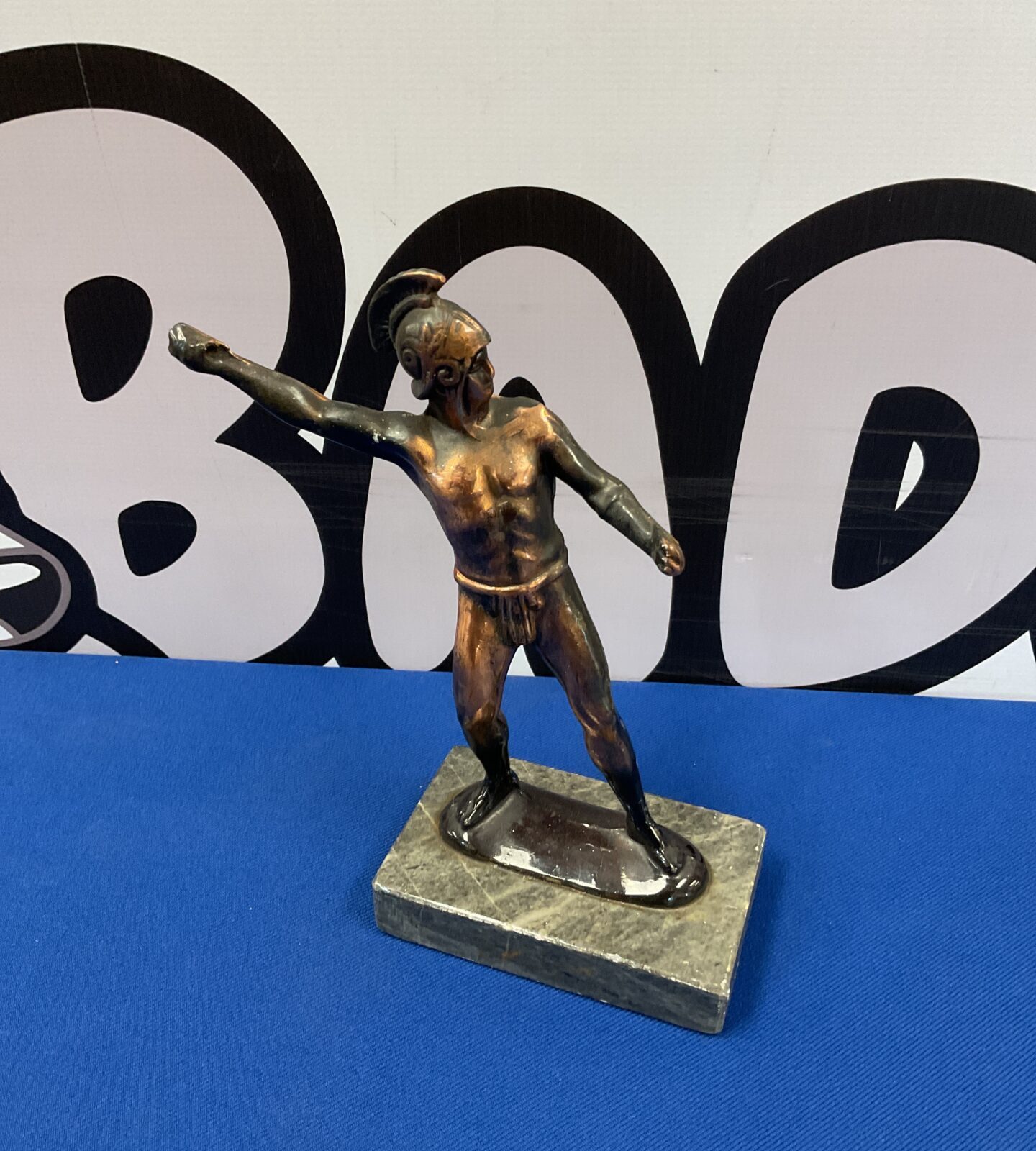 Bronzed sculpture of a roman gladiator on stone base