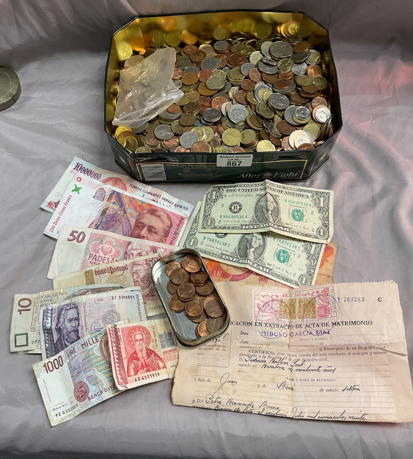 Large tin of assorted coins and bank notes