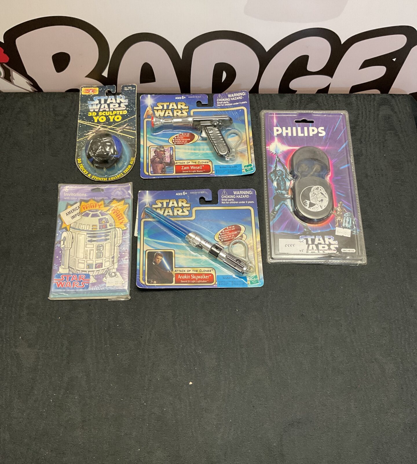 Selection of boxed Retro Star Wars toys and accessories inc philips star wars headphones, sound and light lightsaber and blaster, 3d sculpted yo yo and party invitation