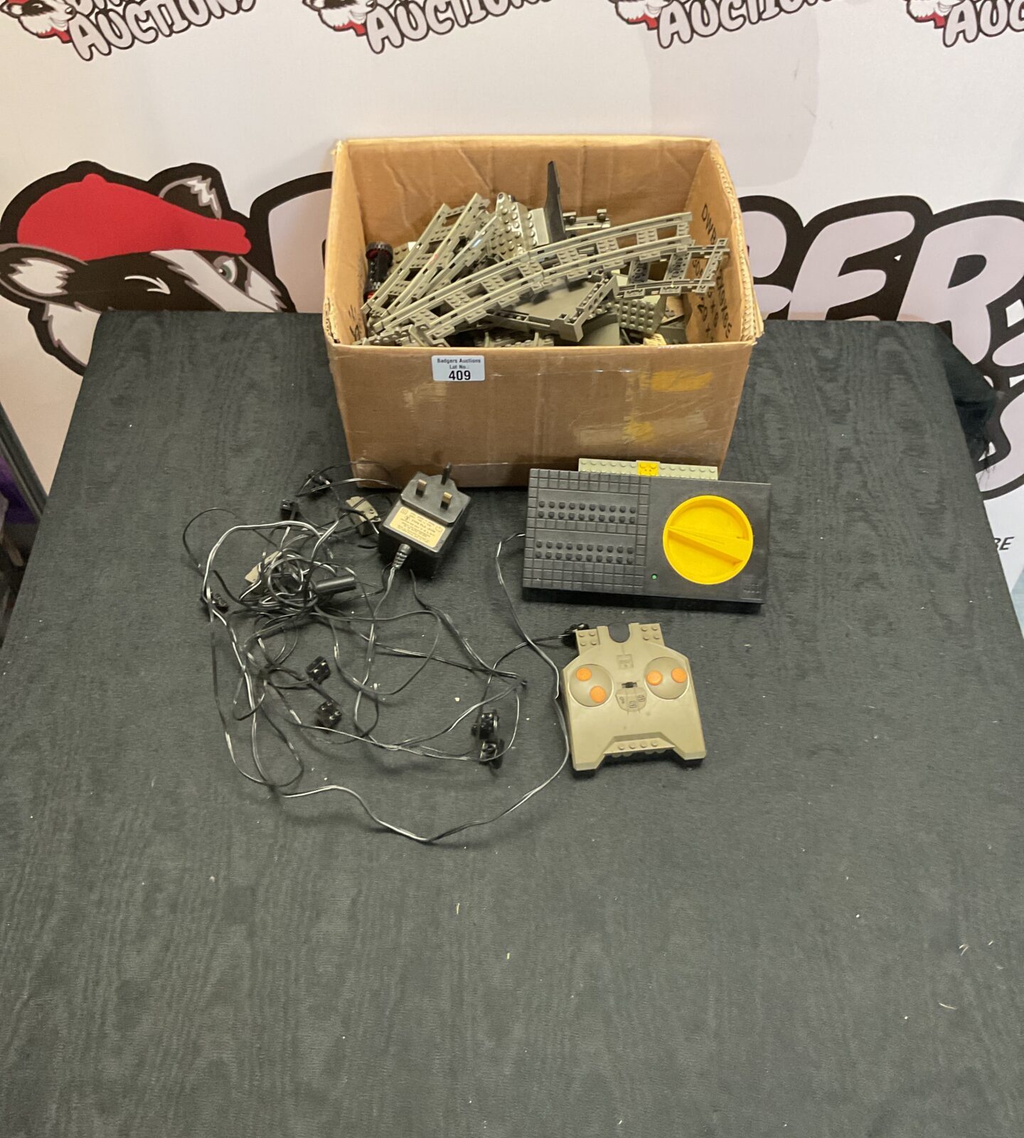 Box of vintage Lego train tracks, parts and remote