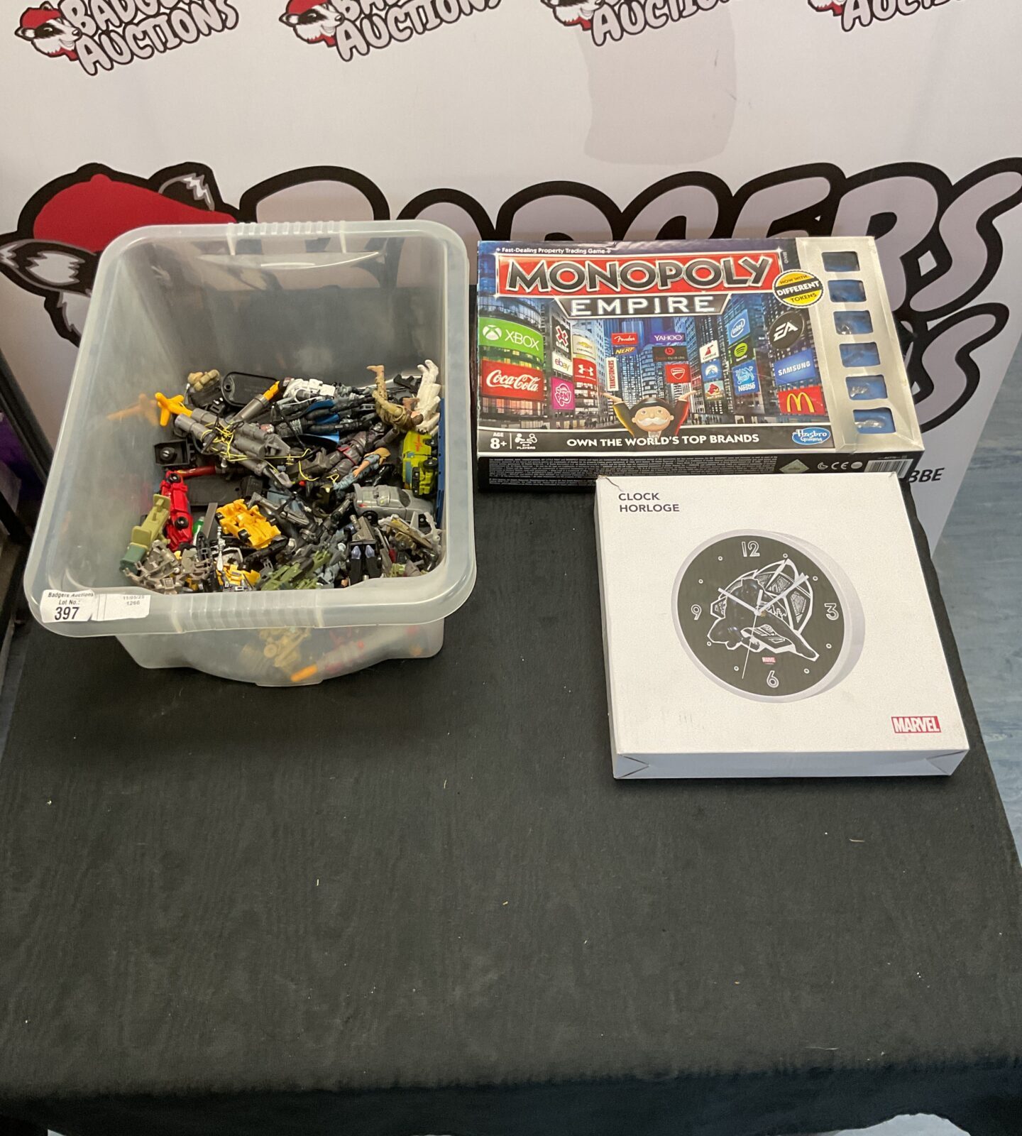 Box containing retro gi-joe figures and accessories, retro transformers , hasbro monopoly empire and marvel black panther clock