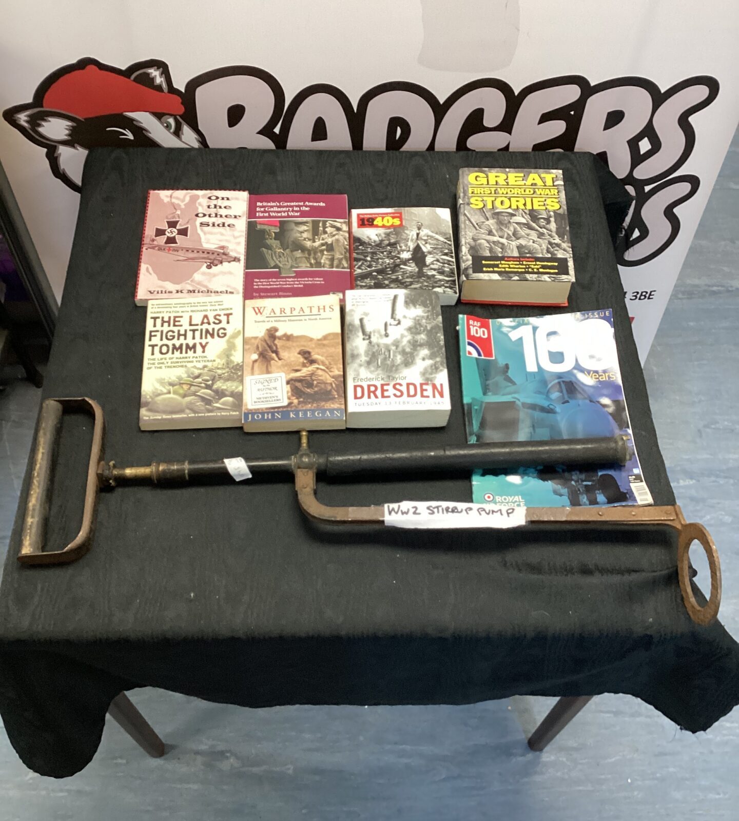 WWII stirrup pump with a collection of military & war related books
