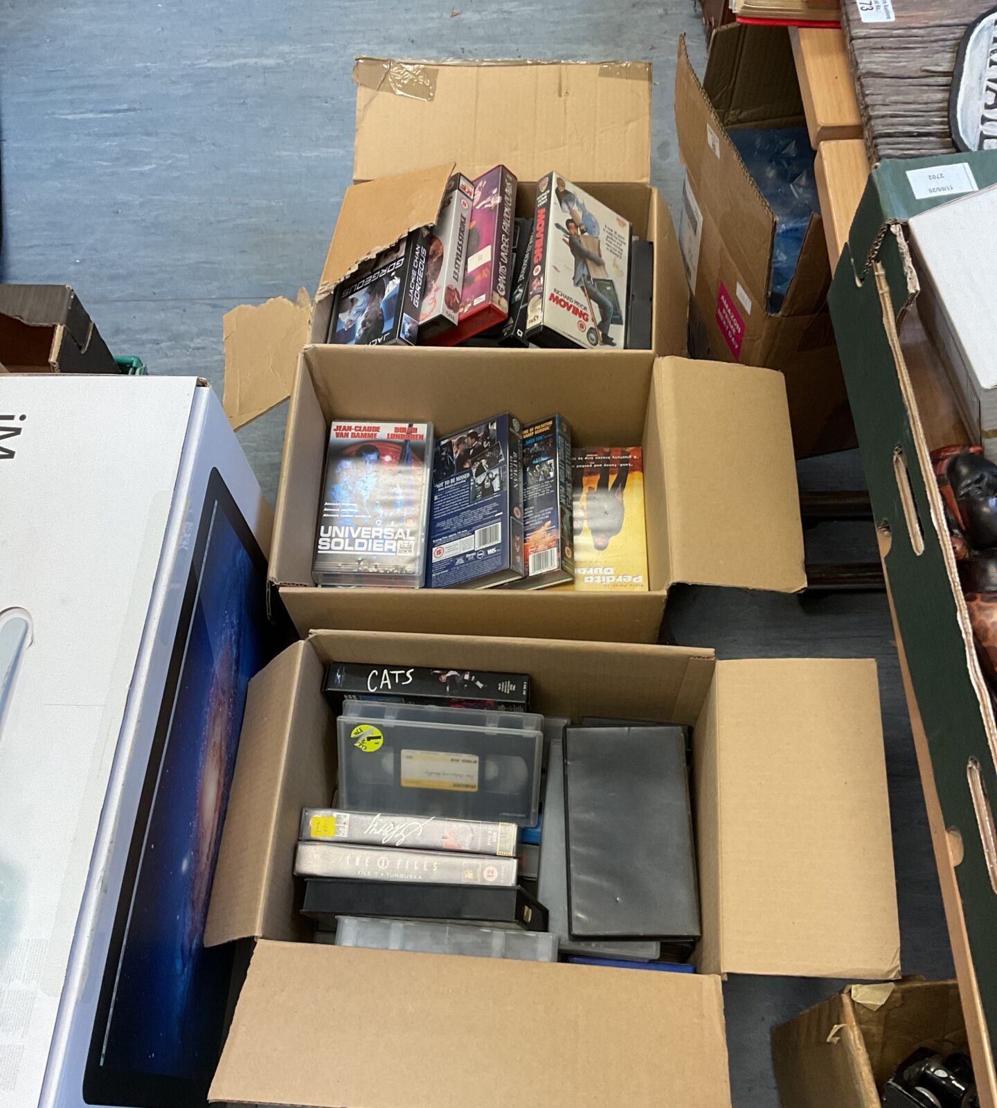 Three boxes of vhs movie cassettes
