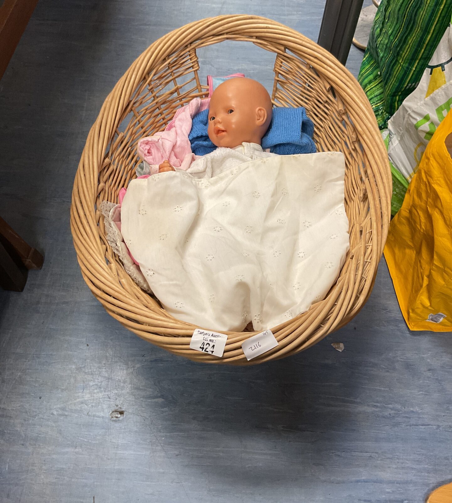 Wicker basket containing small baby doll