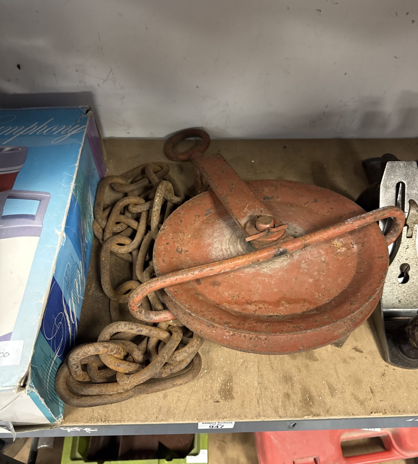 Large vintage pulley wheel with length of chain