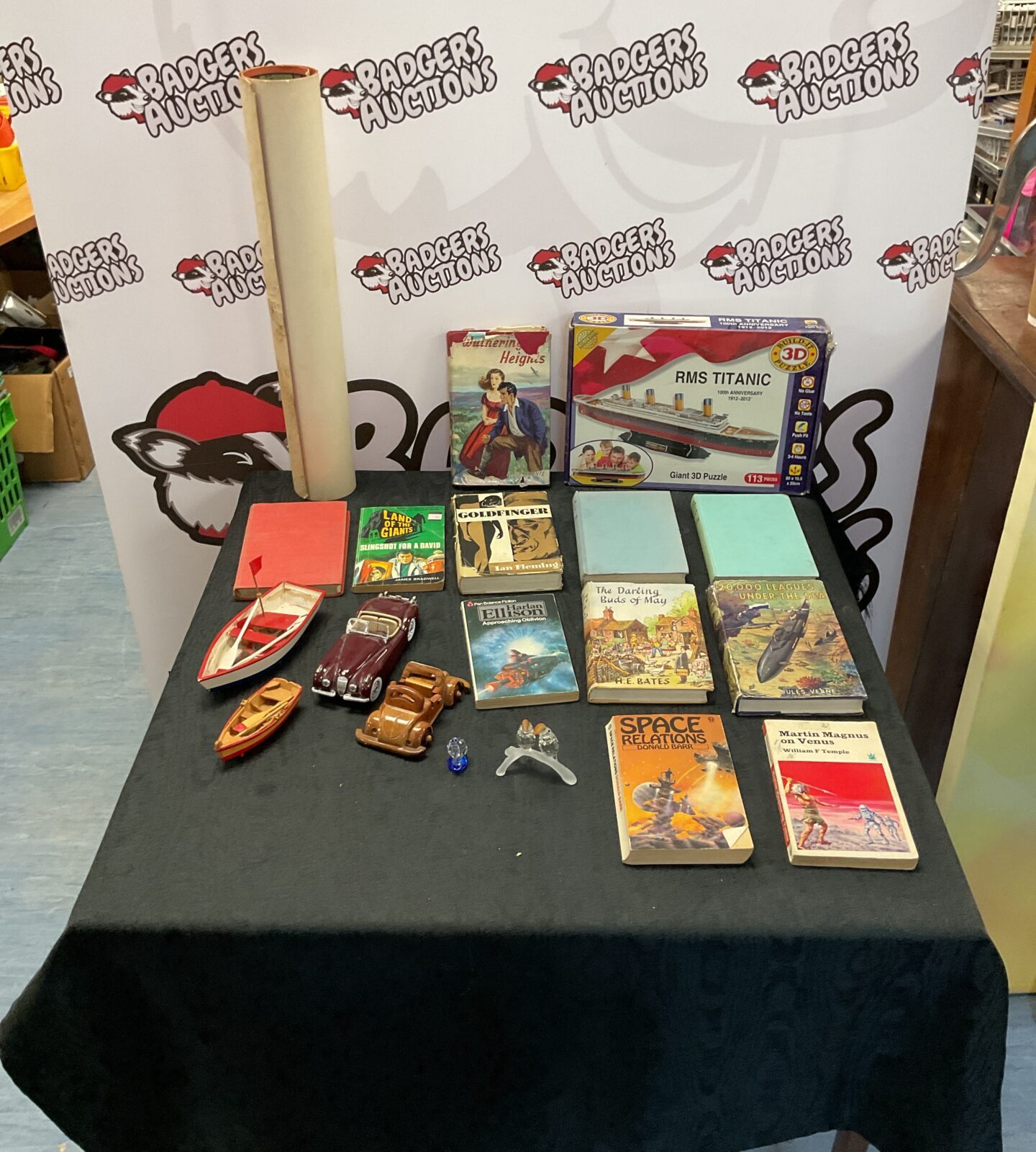 Box of mixed items inc burago diecast model, vintage books, swarofski crystal animals and tarzan poster
