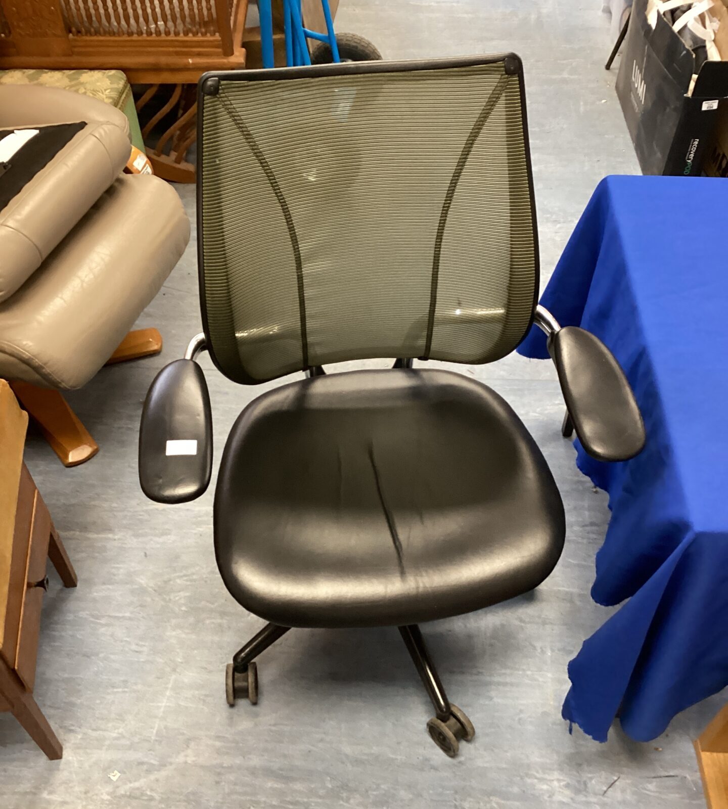 Black leather swivel chair with mesh back