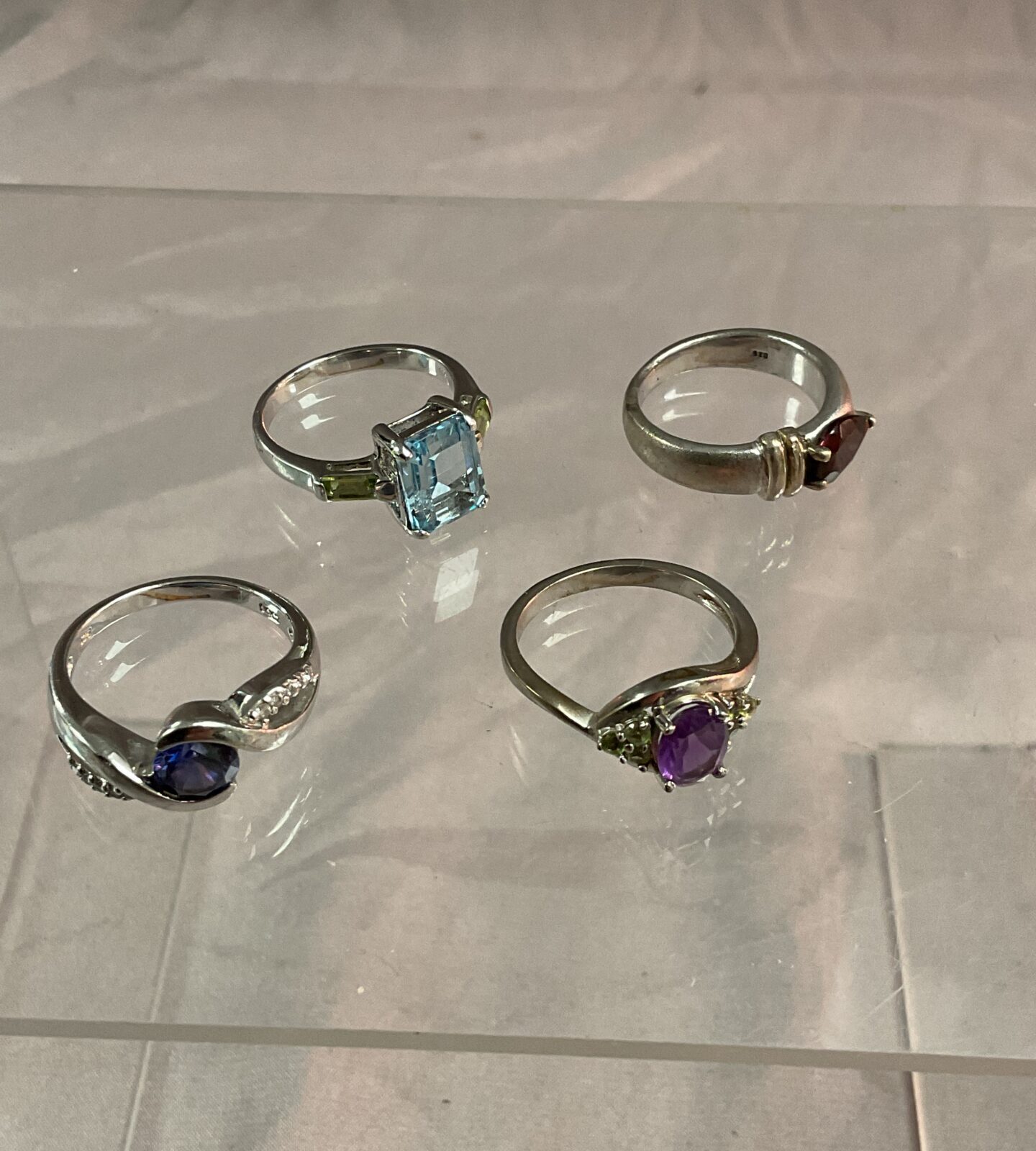 Four Sterling Silver stone set Rings Sizes P N