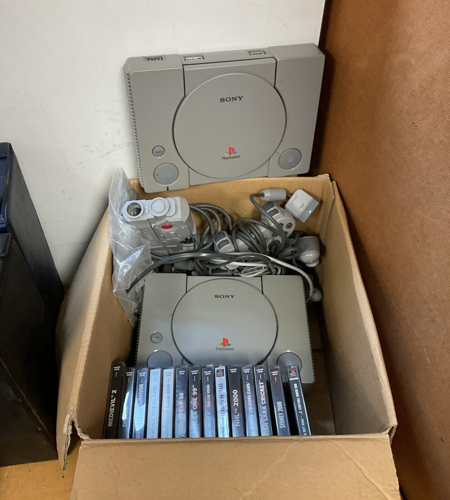 Two sony PlayStation consoles with games & controllers