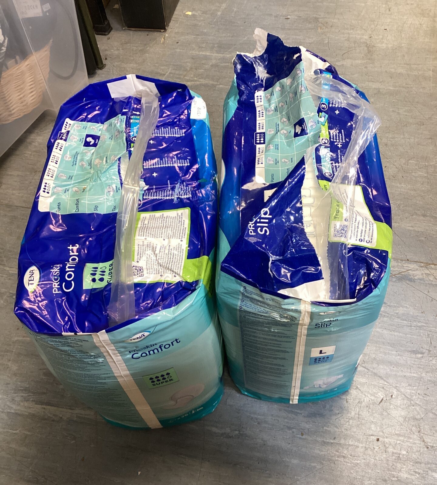 Two packs of tena pads sizes super & large