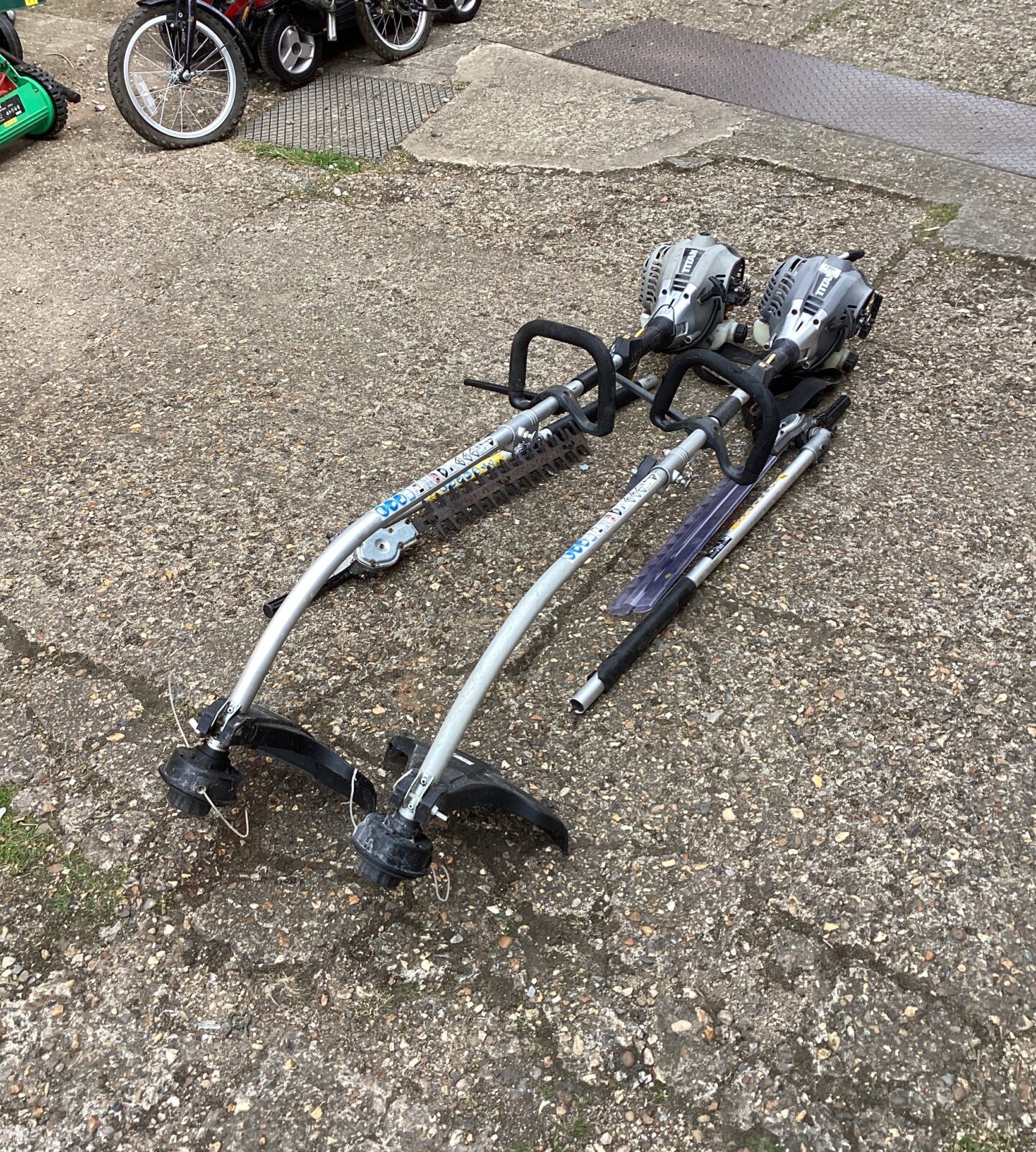 Two Titan petrol strimmers with hedge cutter attachments