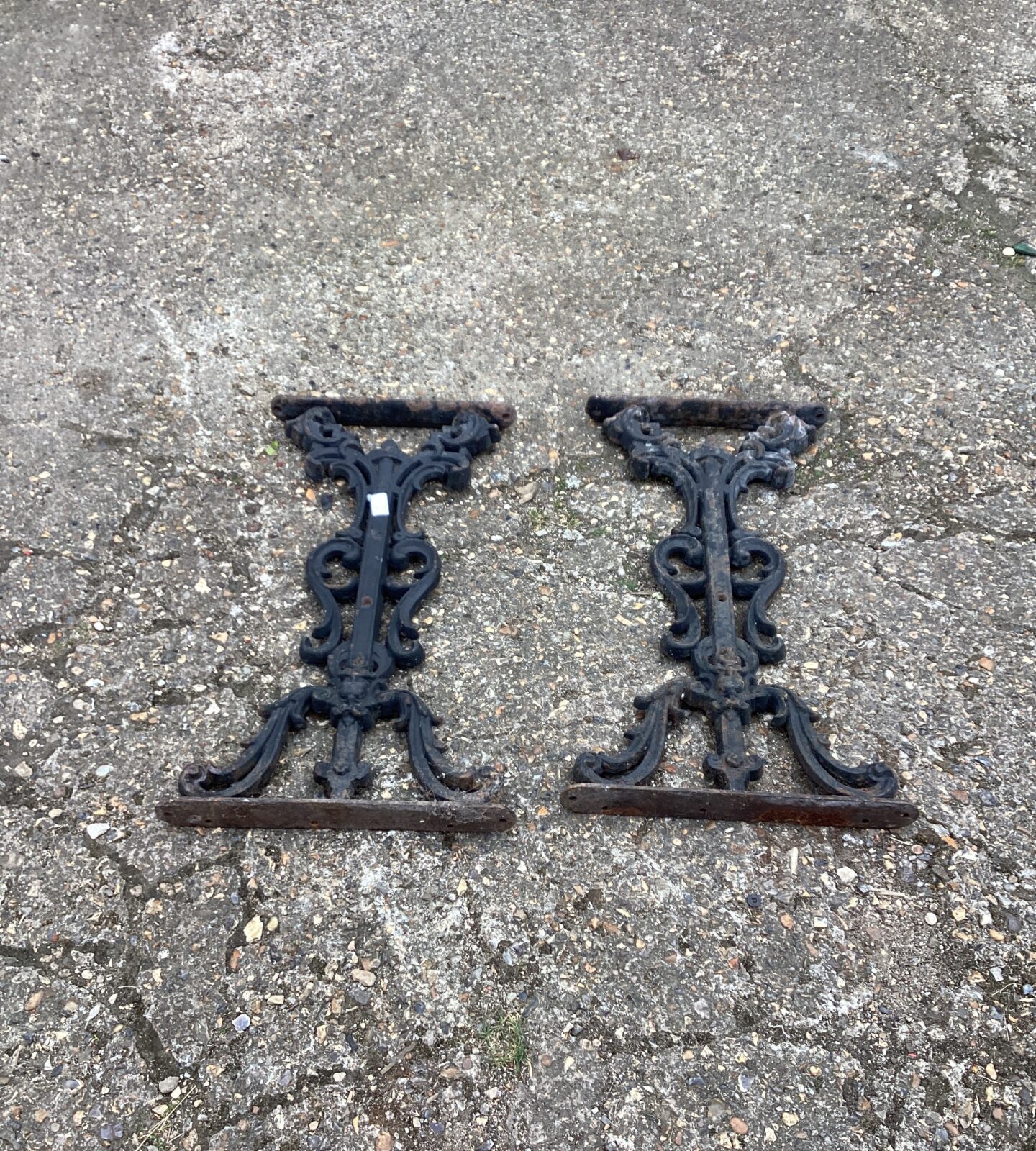 Two wrought iron garden table legs