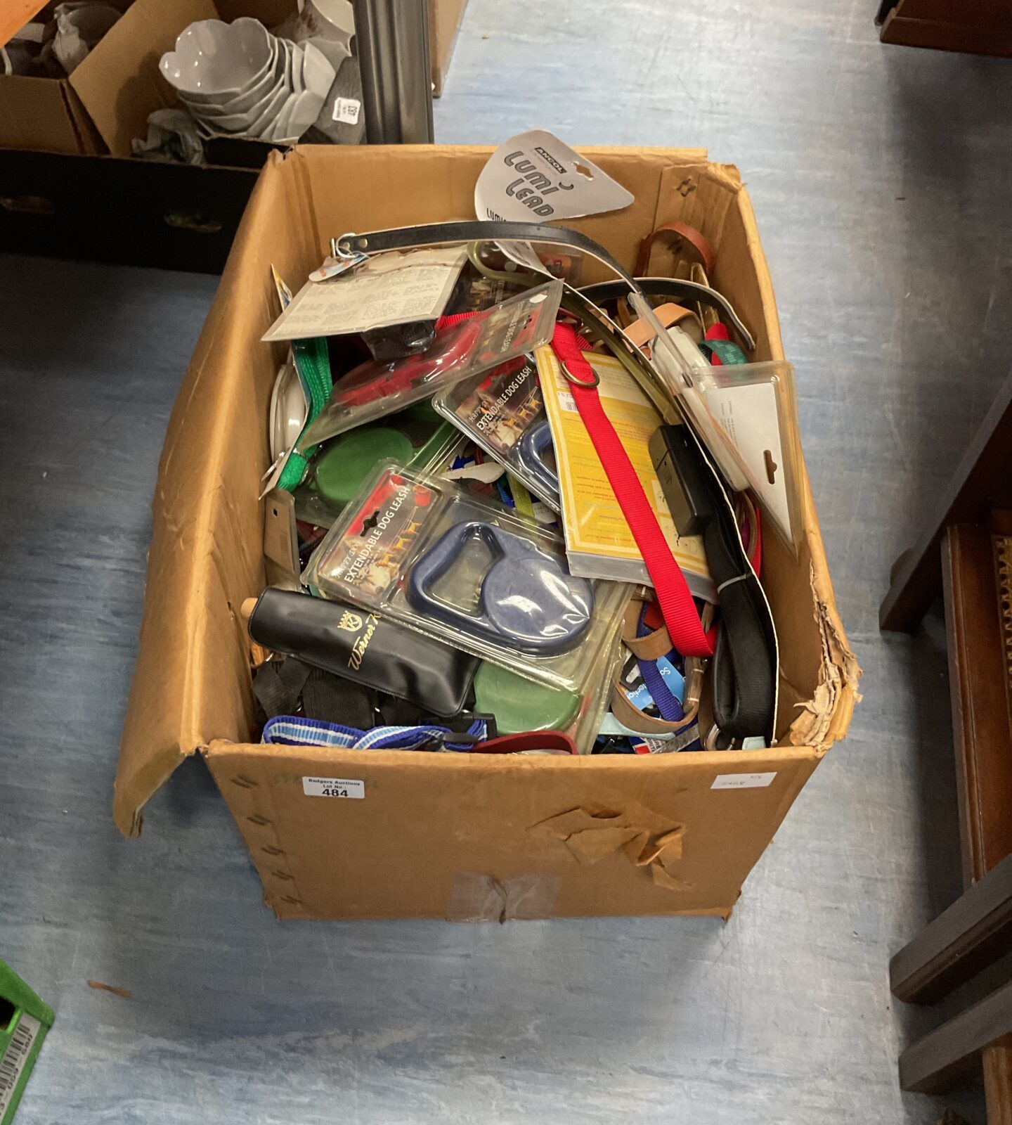 Large box of retractable dog leashes and other leashes