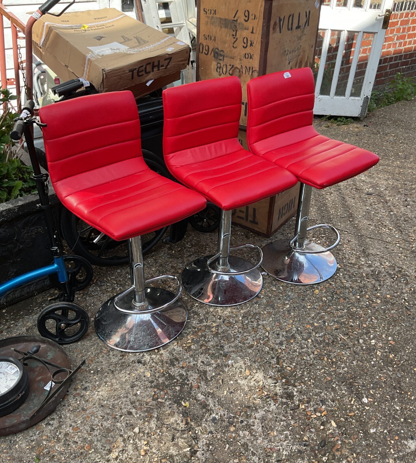Three red cushioned bar stools
