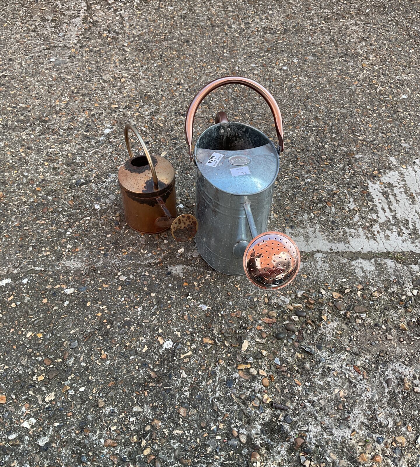 Two galvanised watering cans