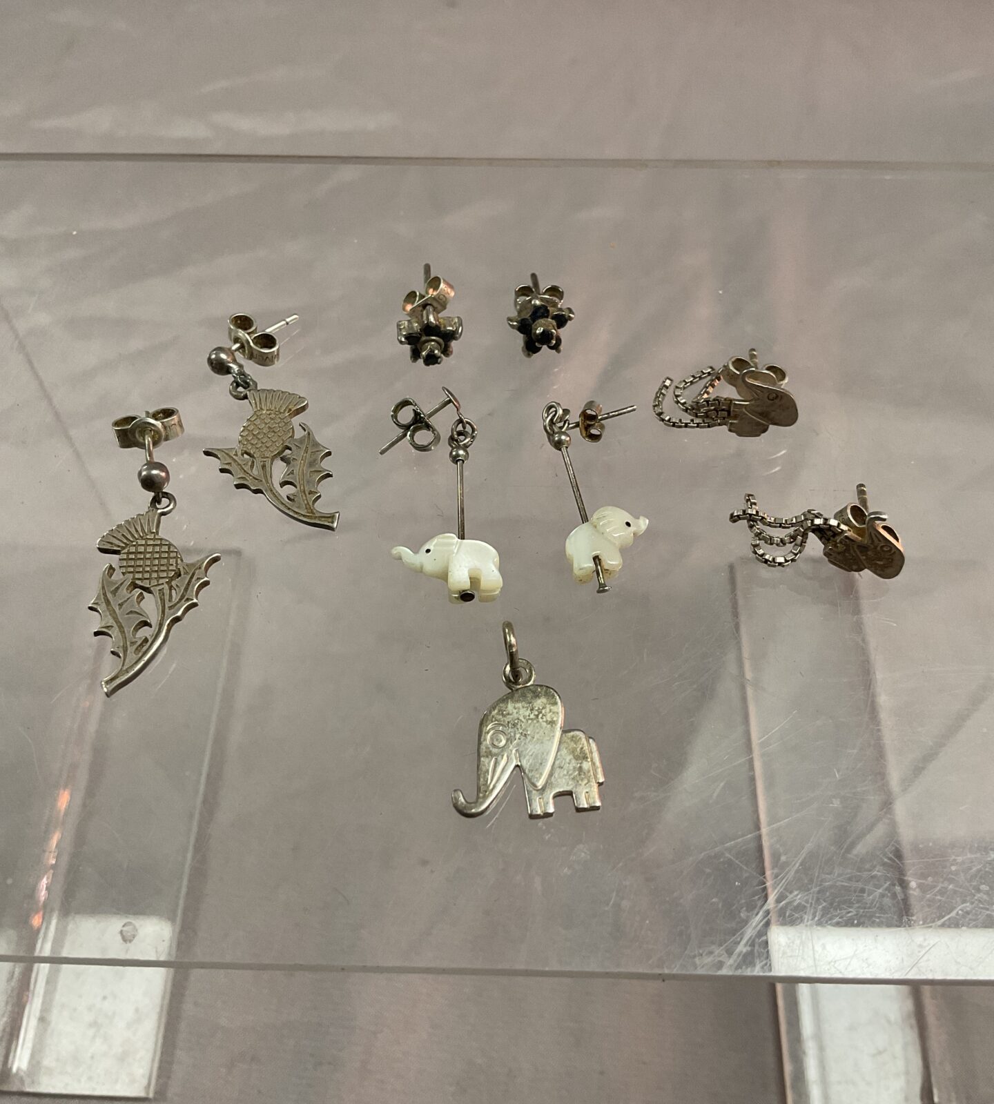 Four pairs of Silver stud earrings and elephant pendant