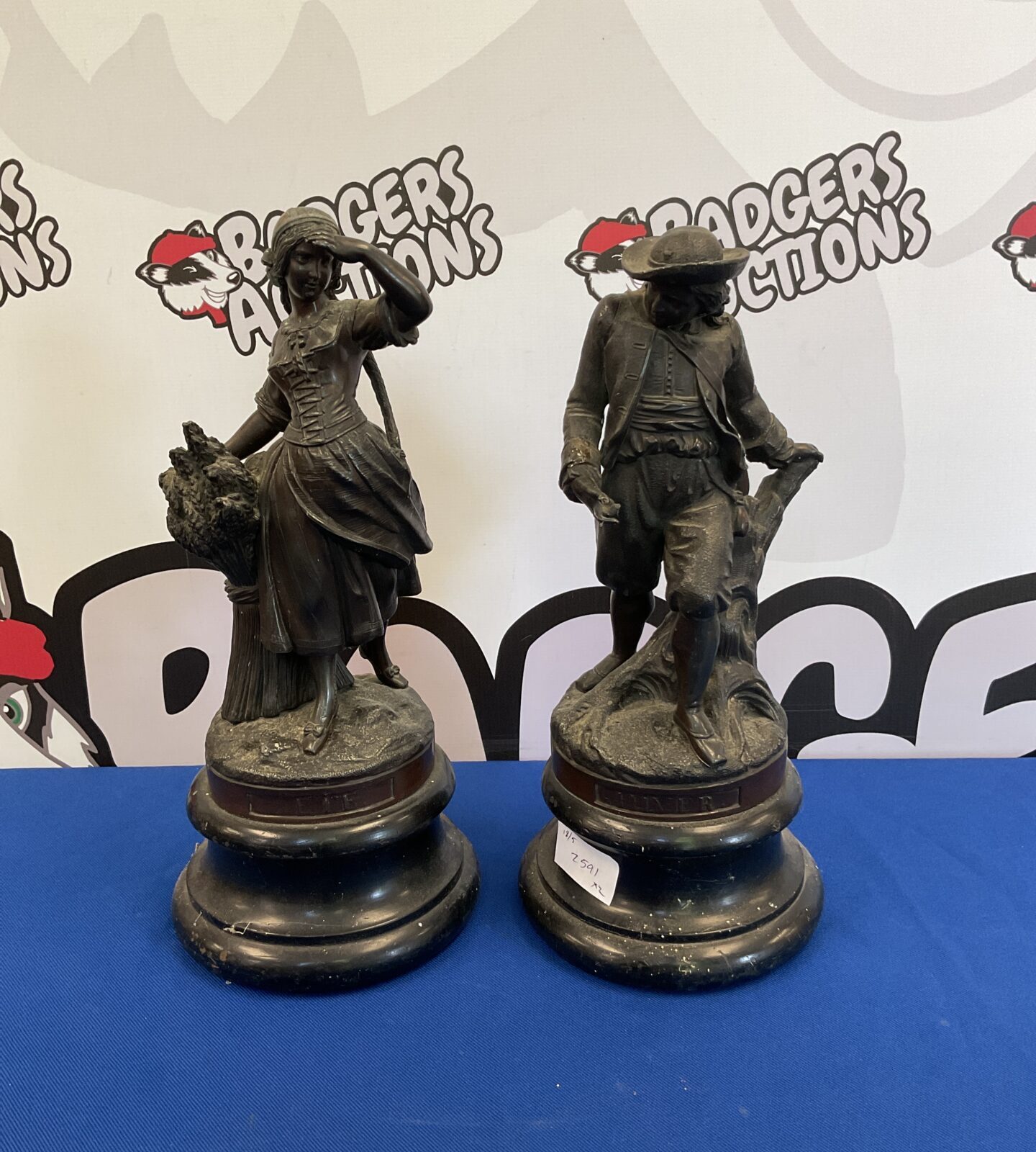 Pair of bronzed spelter hilver & ete figures on plinths