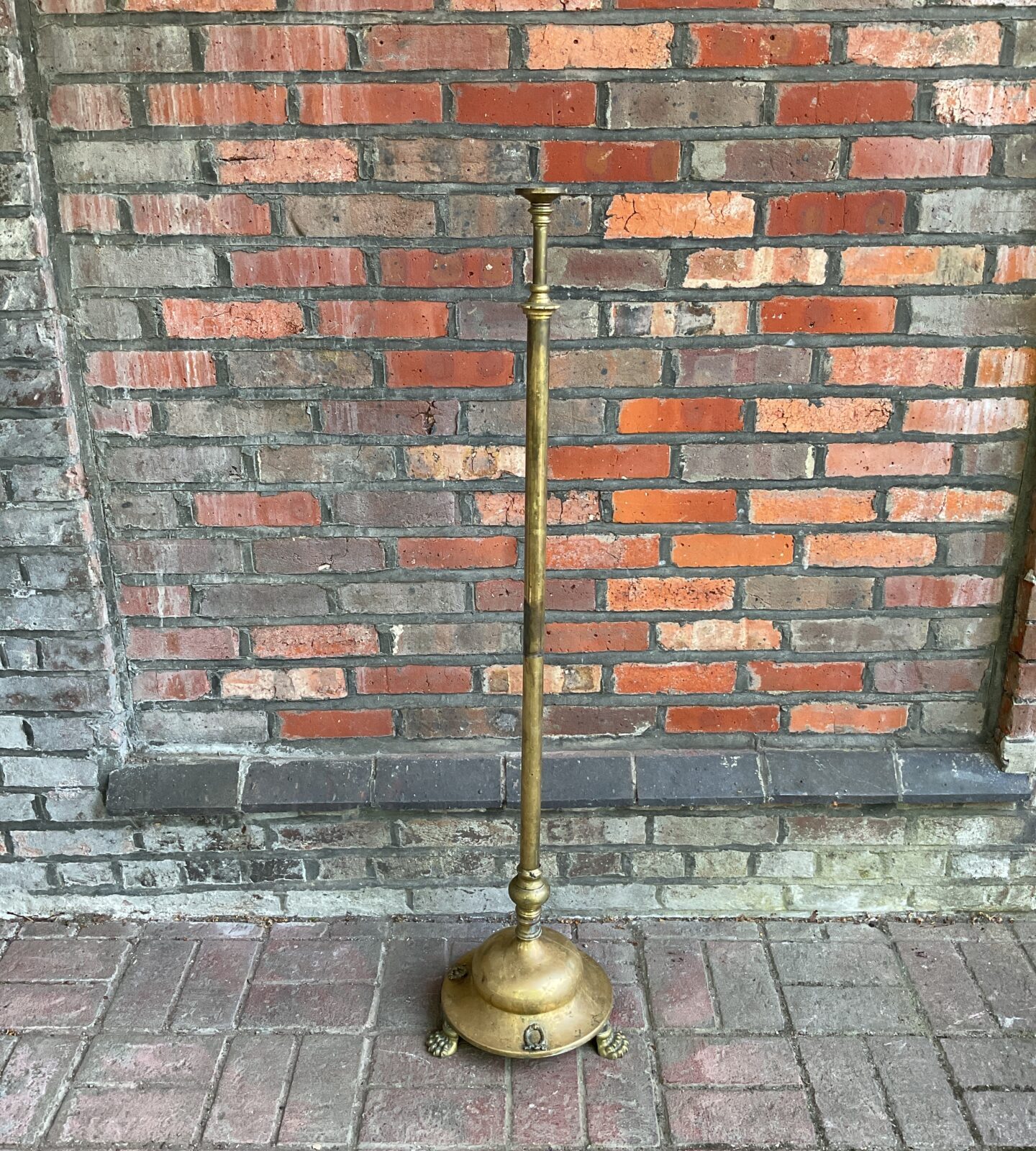 Large brass church floor standing candlestick with clawed feet