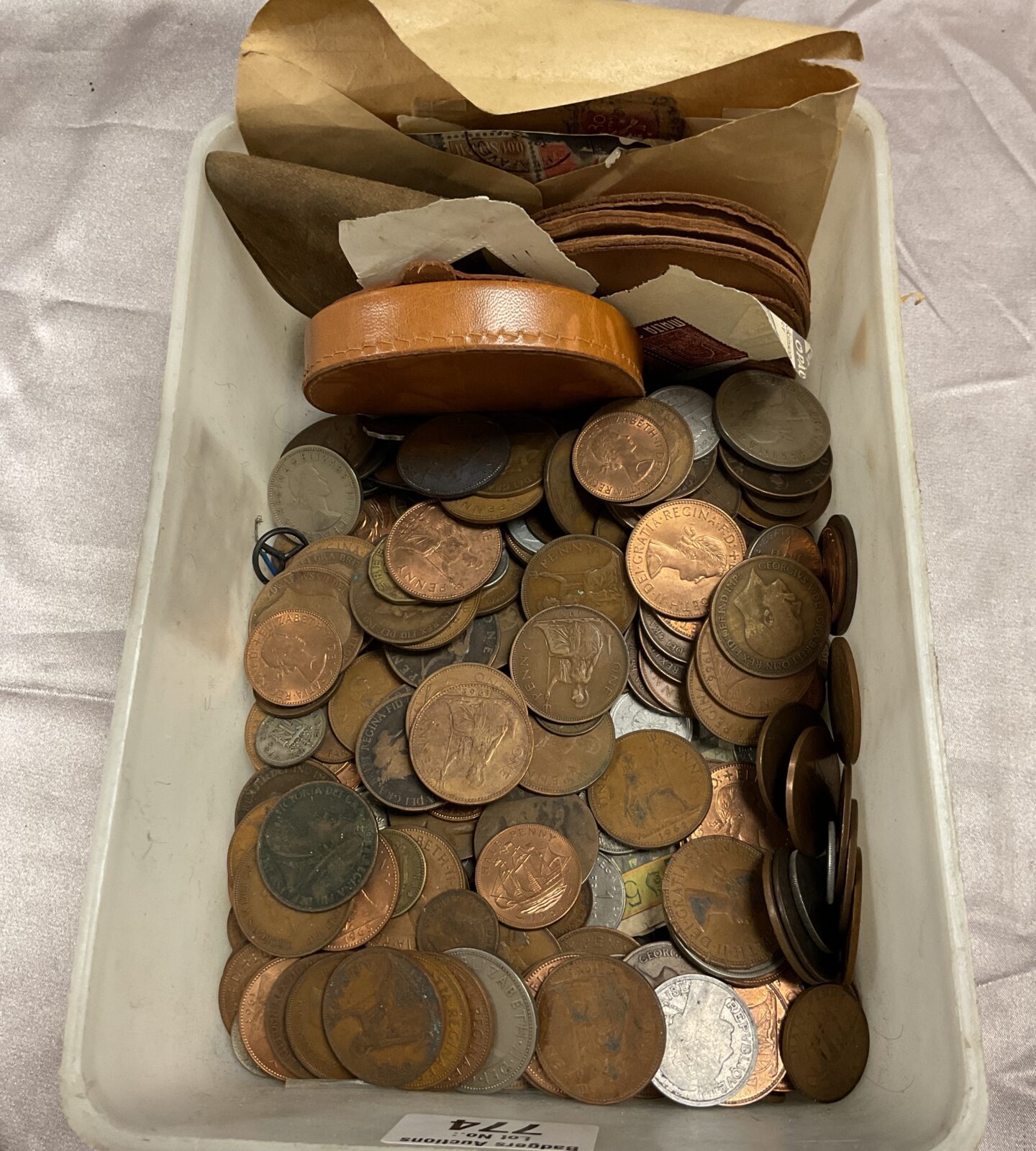Tub of assorted coins Inc purses and postage stamps