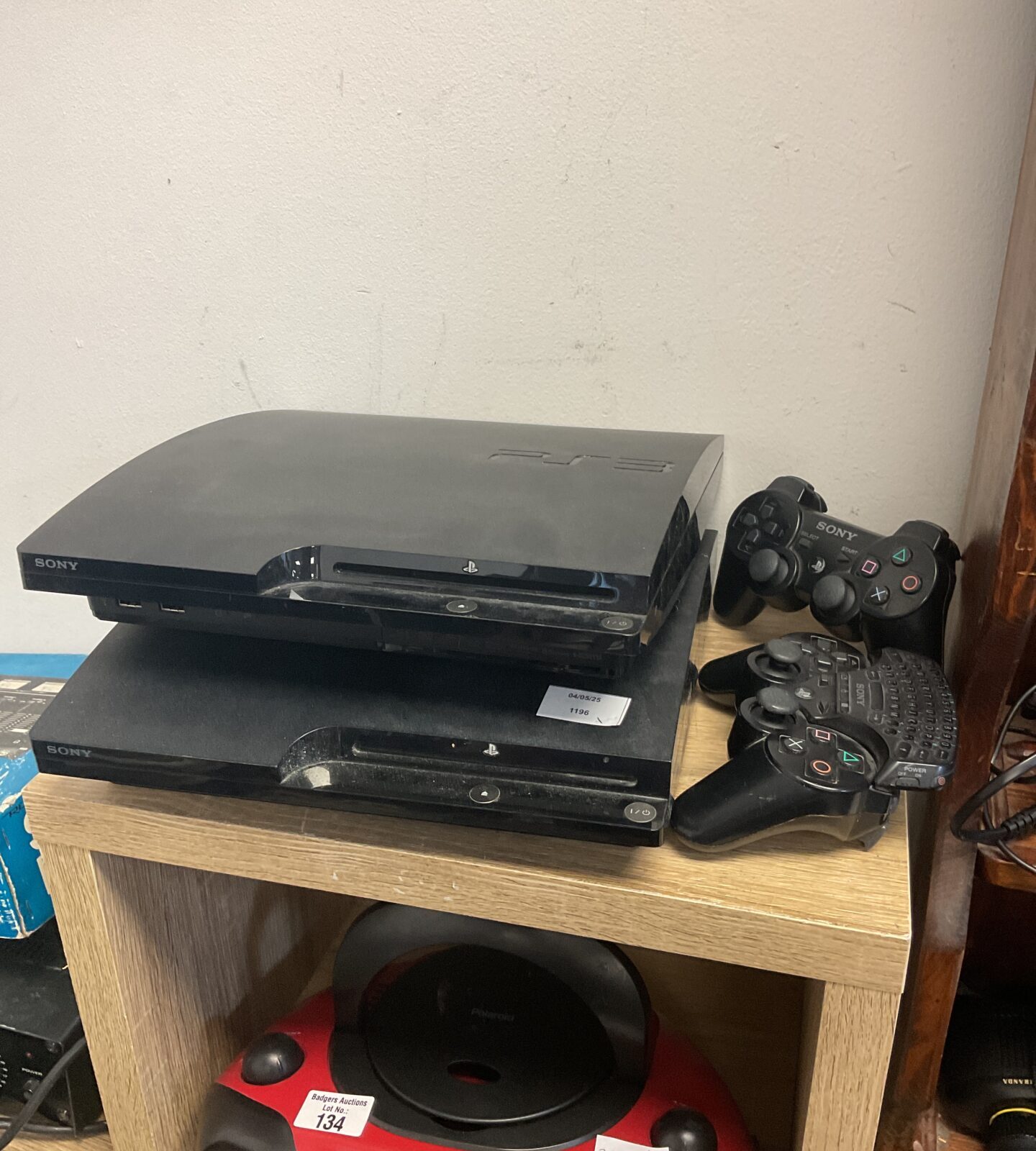 Two sony PlayStation 3 slim consoles with controllers
