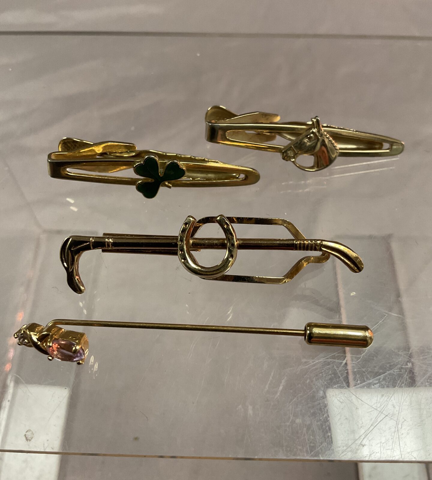Three Horse related Tie clips and a stick pin
