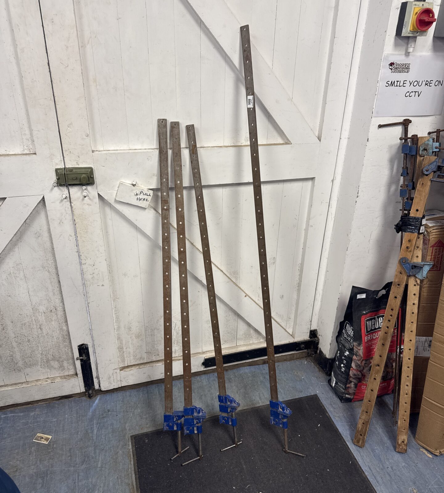 Four large metal sash clamps