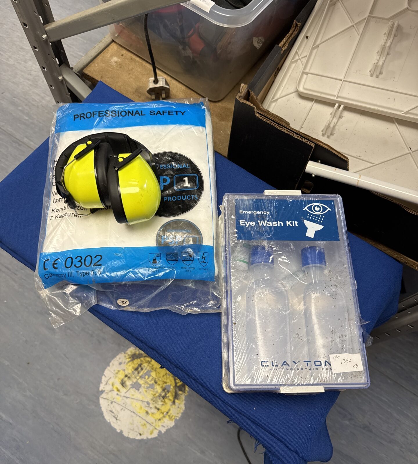 Set of protective earguards, hooded overalls & an eye wash station