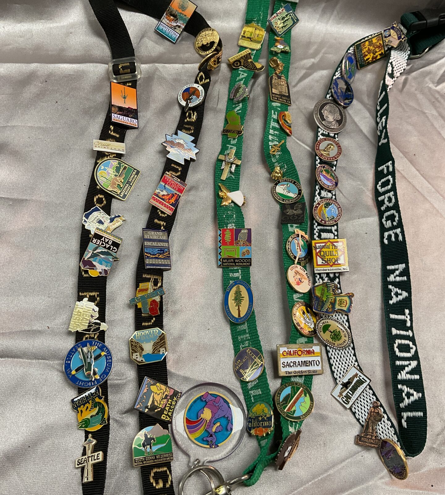 Three lanyards With over 50 Enamelled pin badges Collected over time on trips to the states
