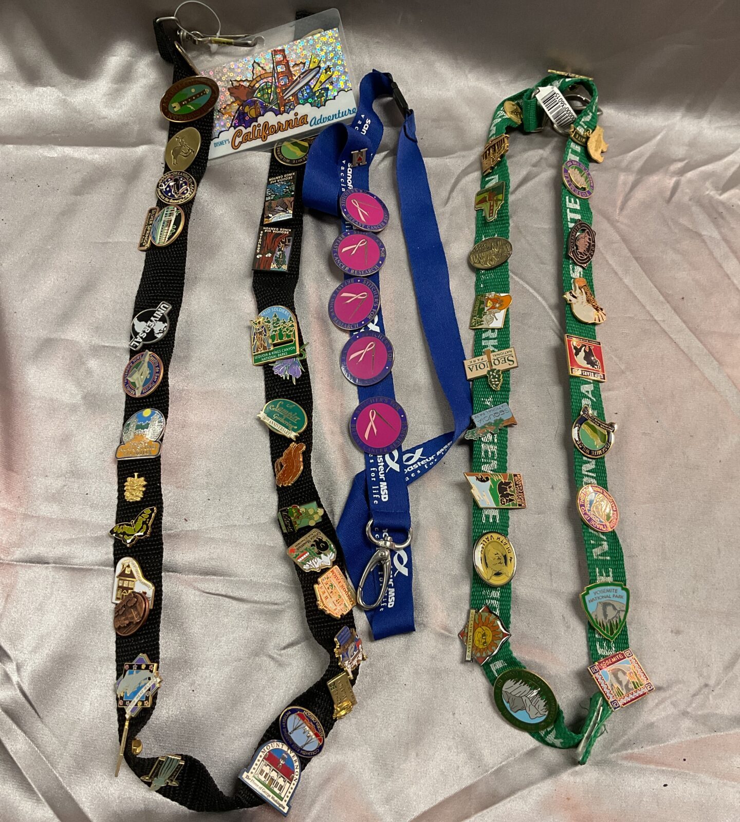 Three lanyards With over 50 Enamelled pin badges Collected over time on trips to the states