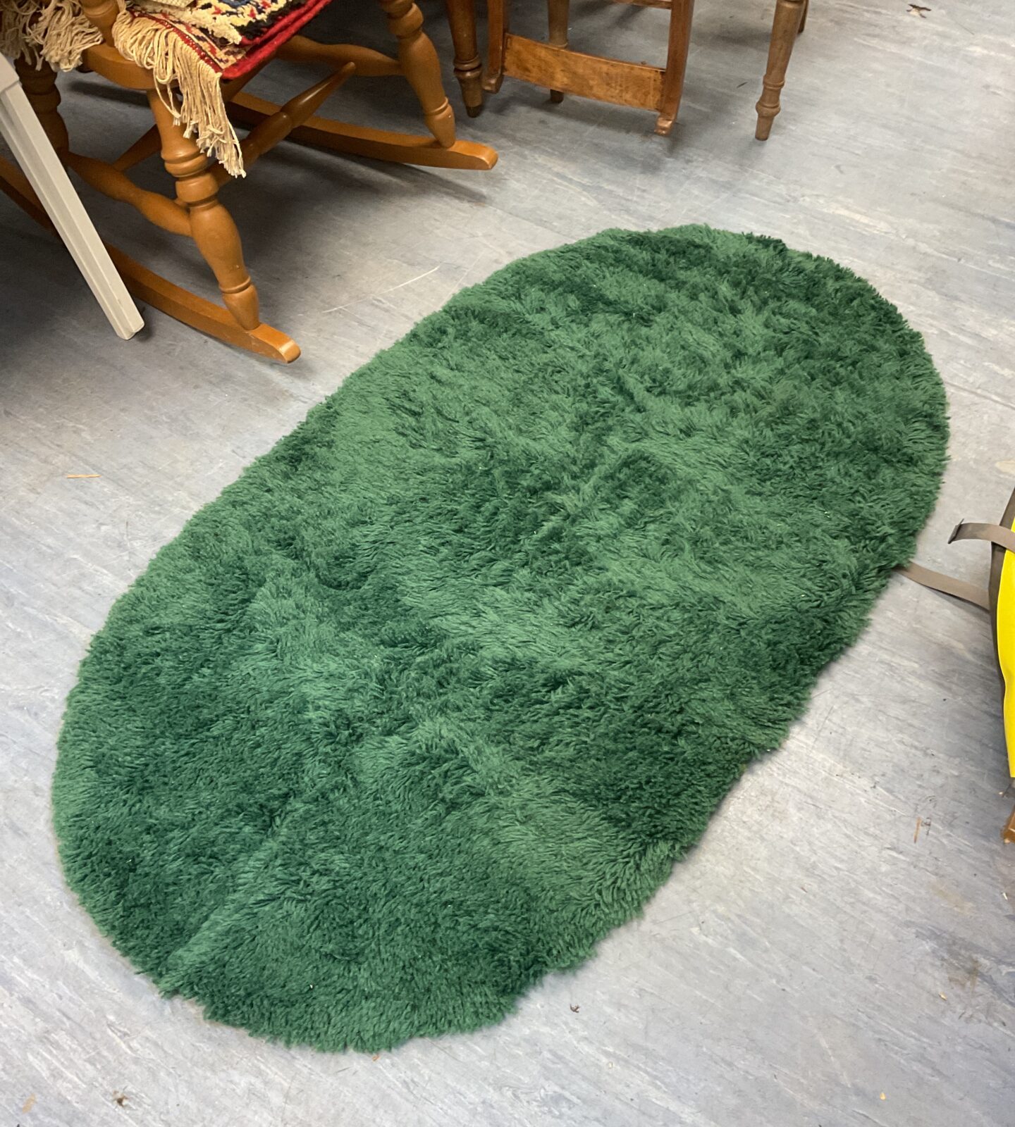 Small oval green shag pile rug