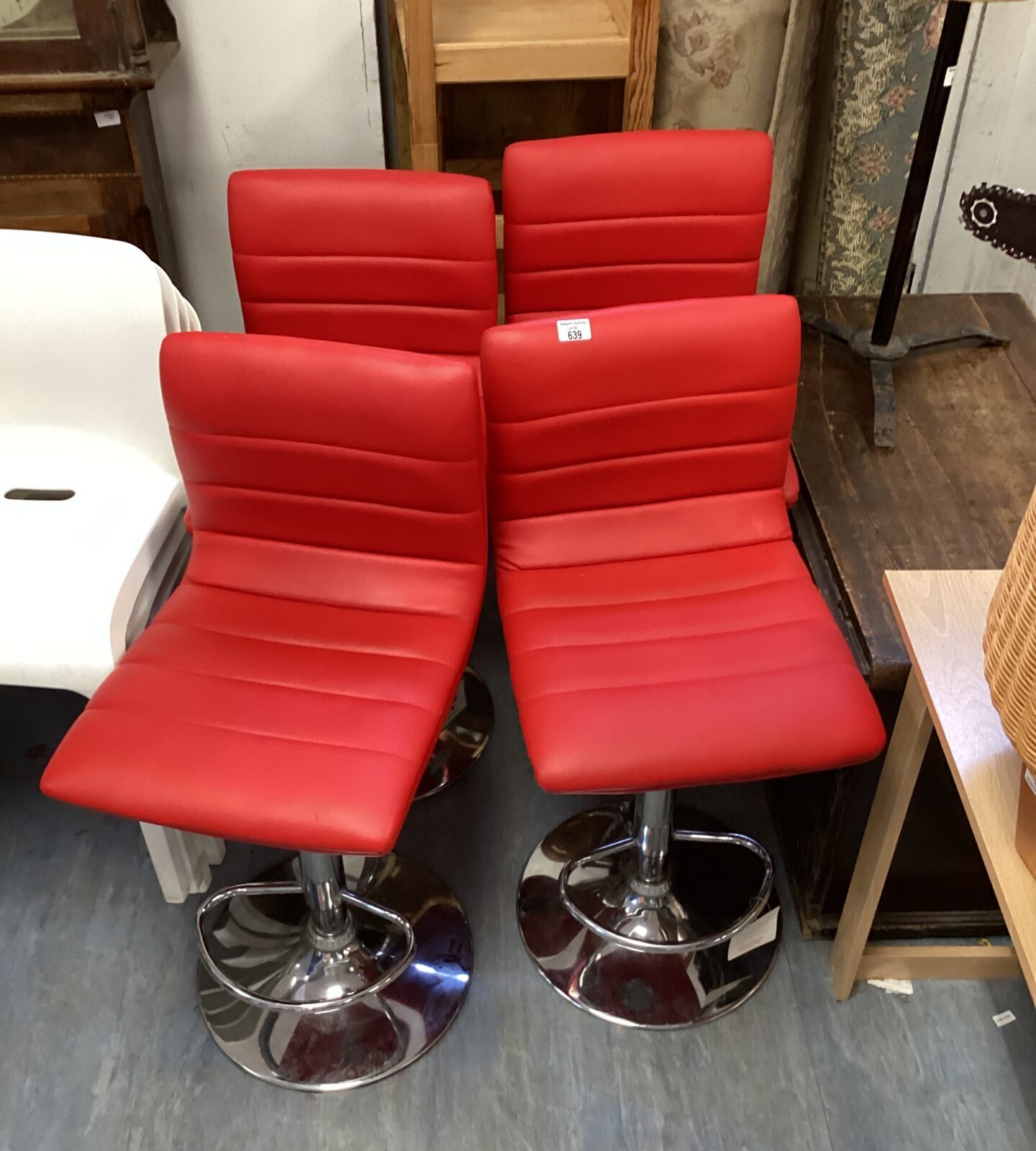 Four red leather bar stools