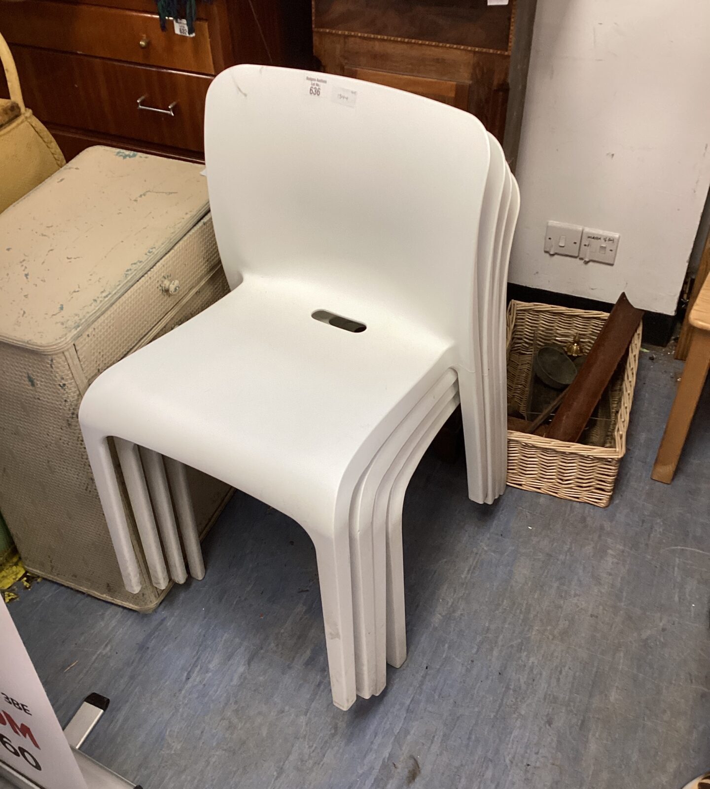 Four white plastic reception chairs