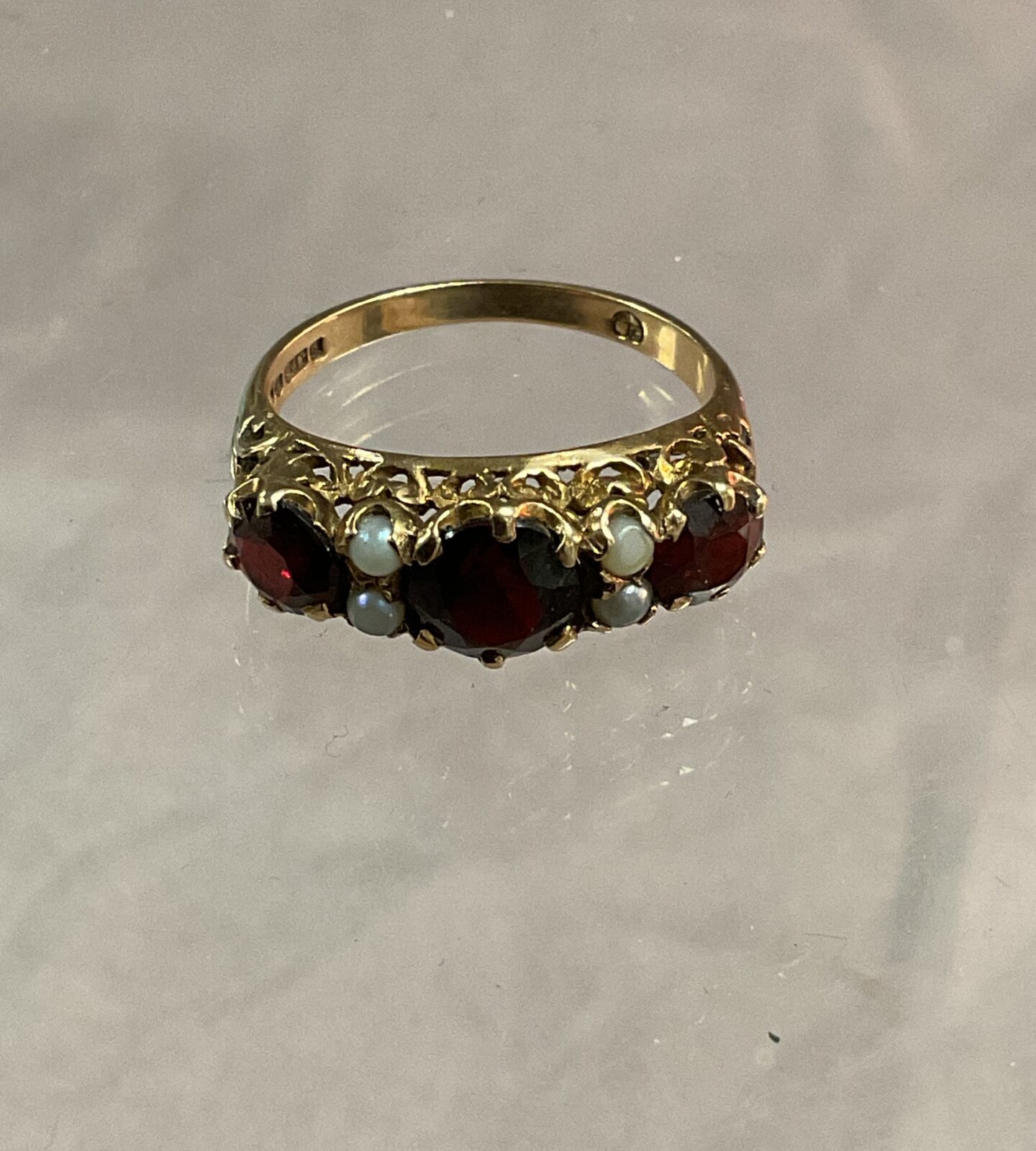9ct Yellow gold ring set with three garnets and four seed pearls Size O 3.18g gross
