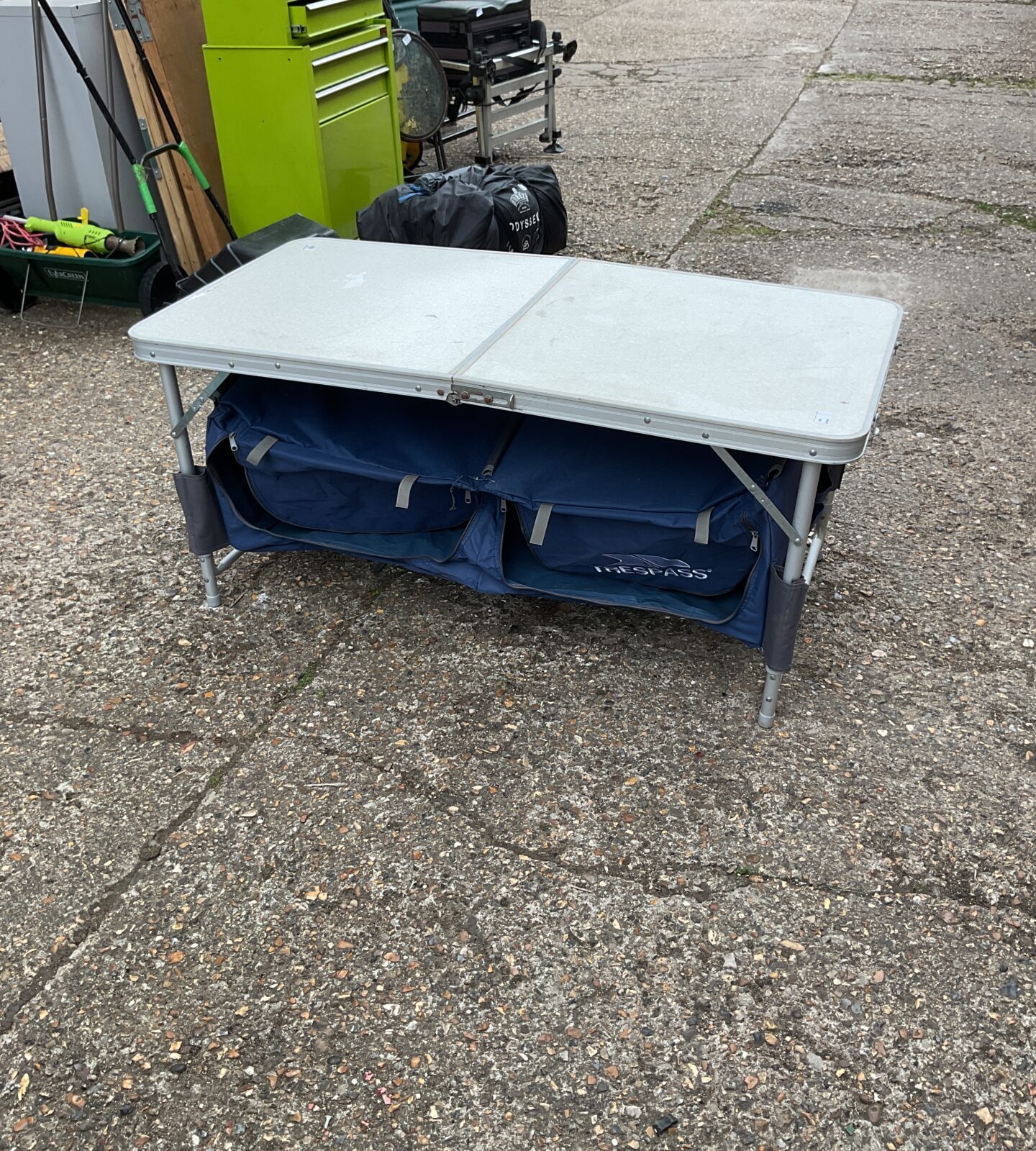 Folding trespass camping table with storage